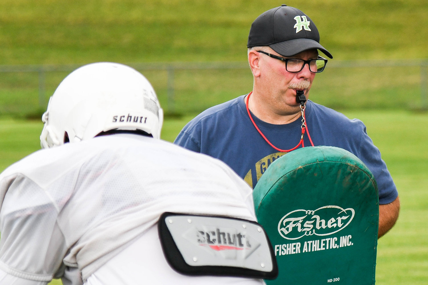 Herkimer head coach Mike Jory runs drills with linemen during practice. Jory is in his second season as Herkimer’s coach.