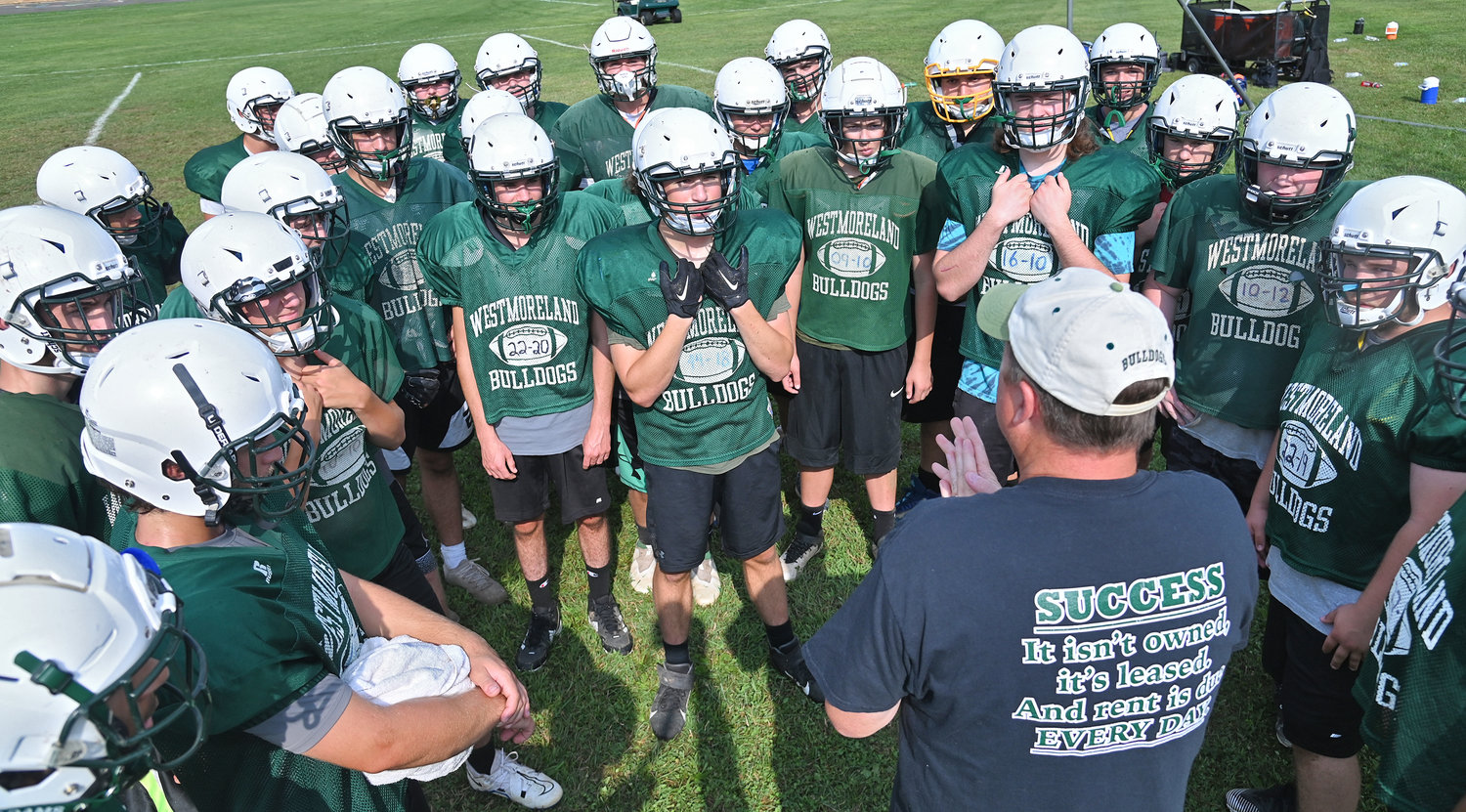 Westmoreland/Oriskany defensive coordinator Greg Williams talks to the team before the Bulldogs break up for defensive drills on Aug. 25.