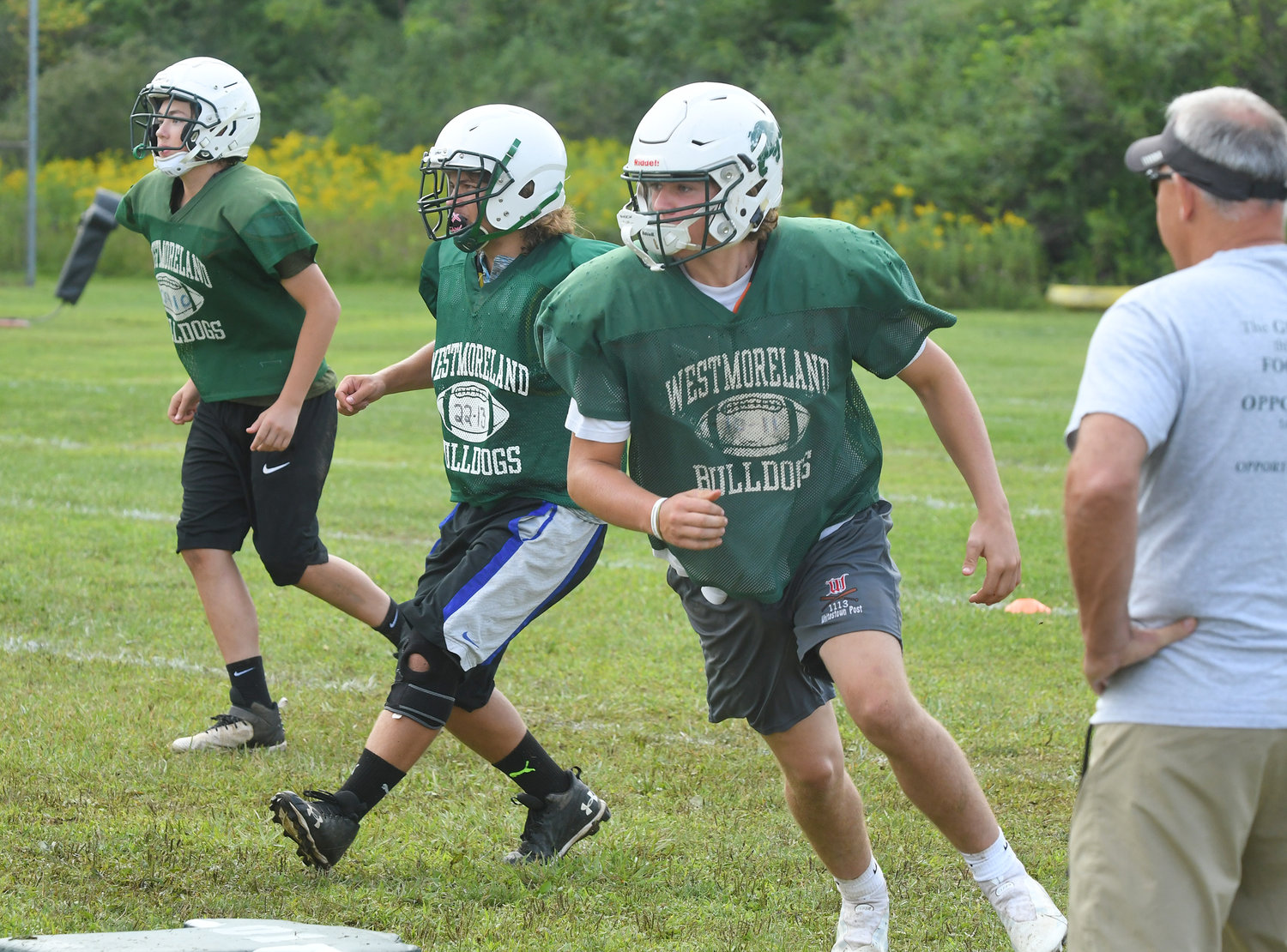 Westmoreland/Oriskany senior defensive end Mitchell Holmes make an around end move in front of assistant coach Jerry Fiorini during morning drills on Aug. 25.