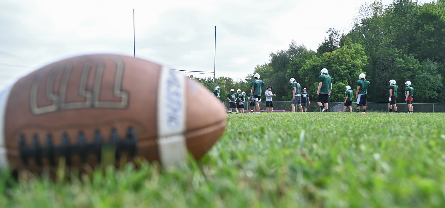 Westmoreland/Oriskany football practice with a football in the foreground on Aug. 25.