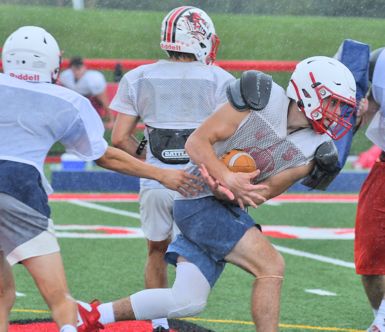 Vernon-Verona-Sherrill senior fullback Matt Rossi takes a handoff from Charlie Foster at Cheveron Field during a preseason practice. Rossi will get carries but his bigger role for the Red Devils will likely be to clear the way for running back James Wheeler IV.