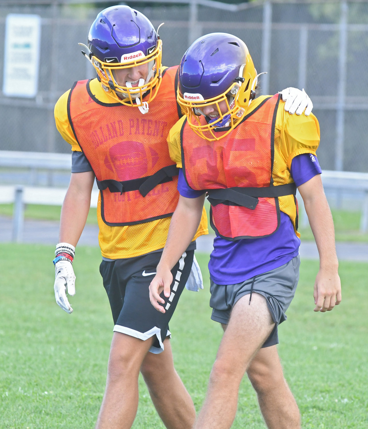 Holland Patent juniors Nick Acevedo, left, and Alex Hoole talk about coverage as they walk back to the huddle during defensive drills at the high school. Acevedo returns as a starting cornerback and Hoole is back at safety.
