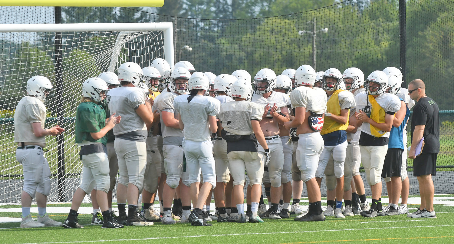 Adirondack football team gathers before getting hydration during a break at practice.
