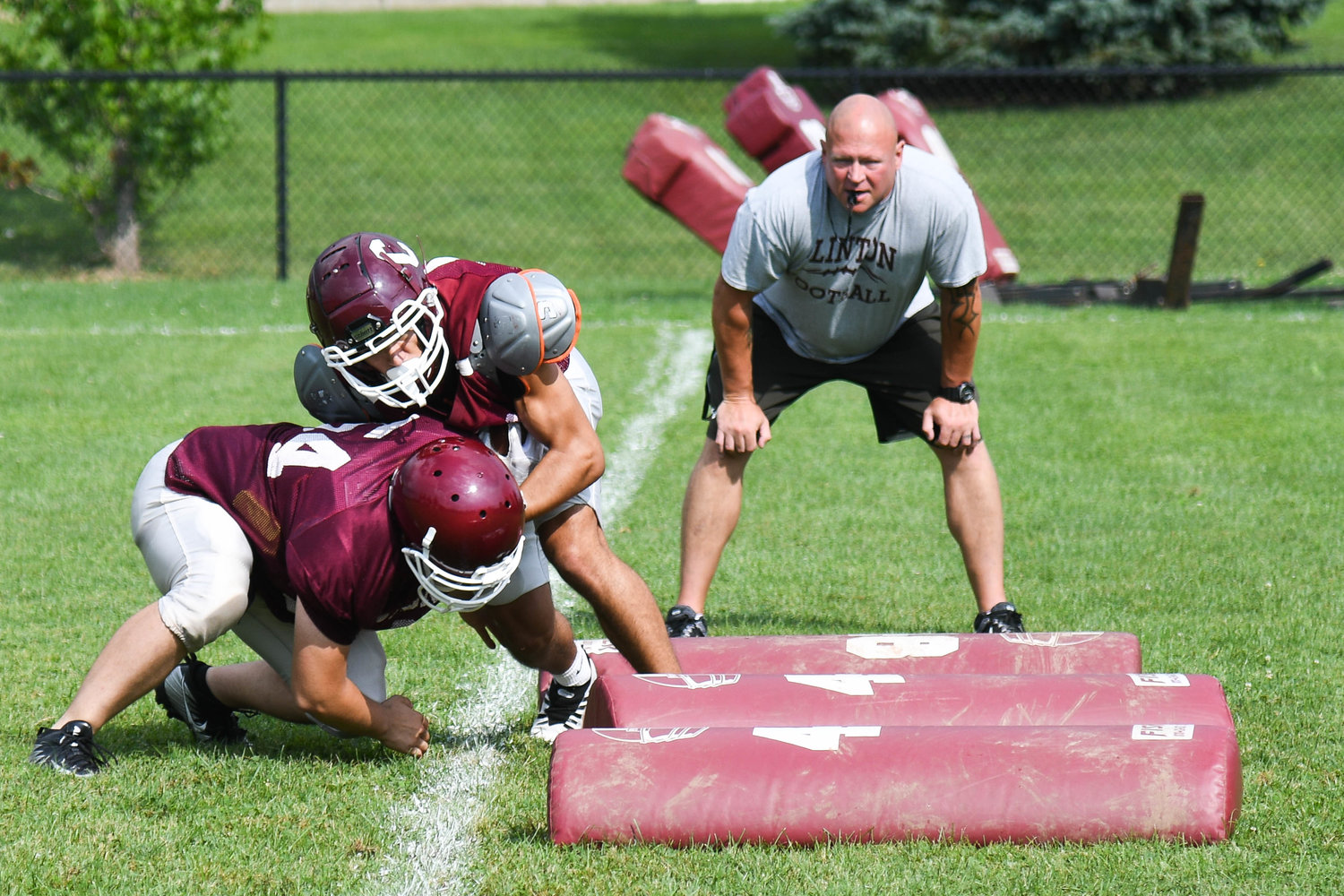 Clinton players work on tackling drills during a recent practice.
