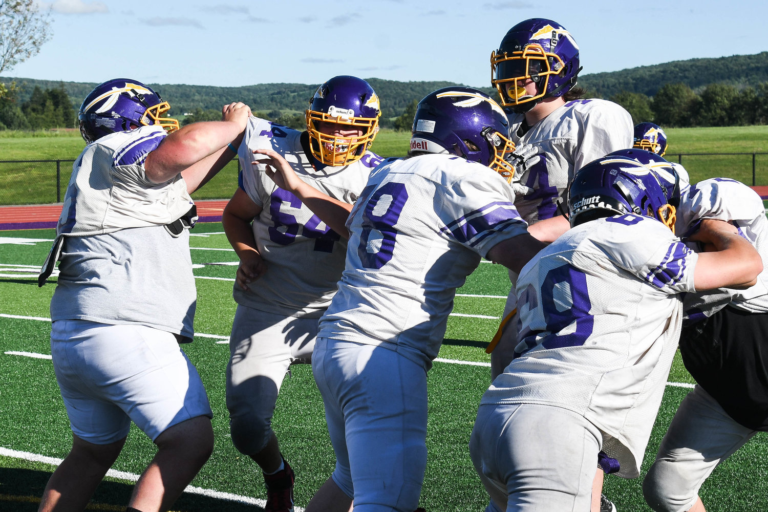 Waterville linemen block defenders during practice earlier this month. The line returns three seniors on a team that includes plenty of younger players.