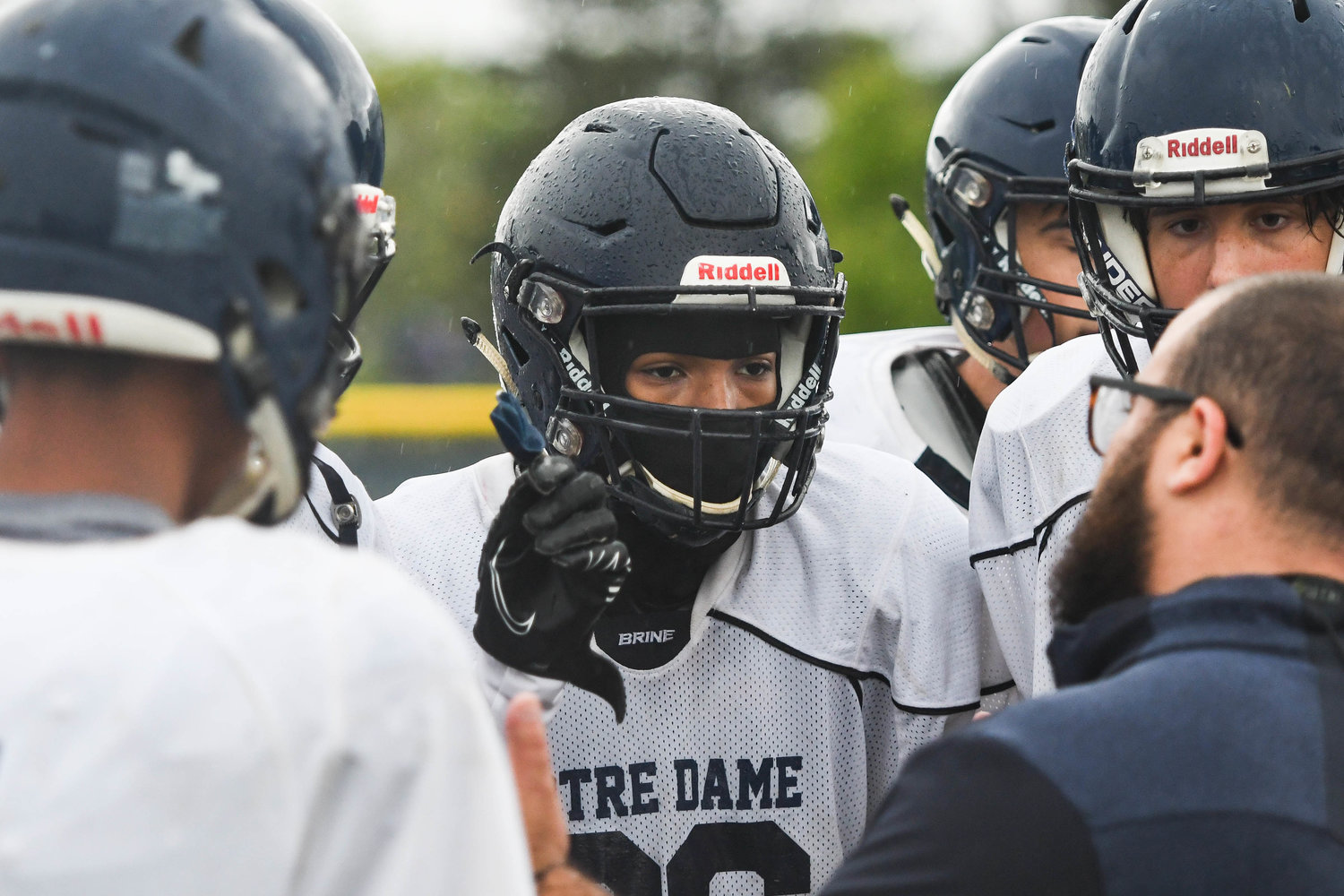 Notre Dame players huddle up for a play in the rain during practice on Aug. 30. Notre Dame technically won three games in fall 2021 but had them taken away because of an ineligible player on the roster.