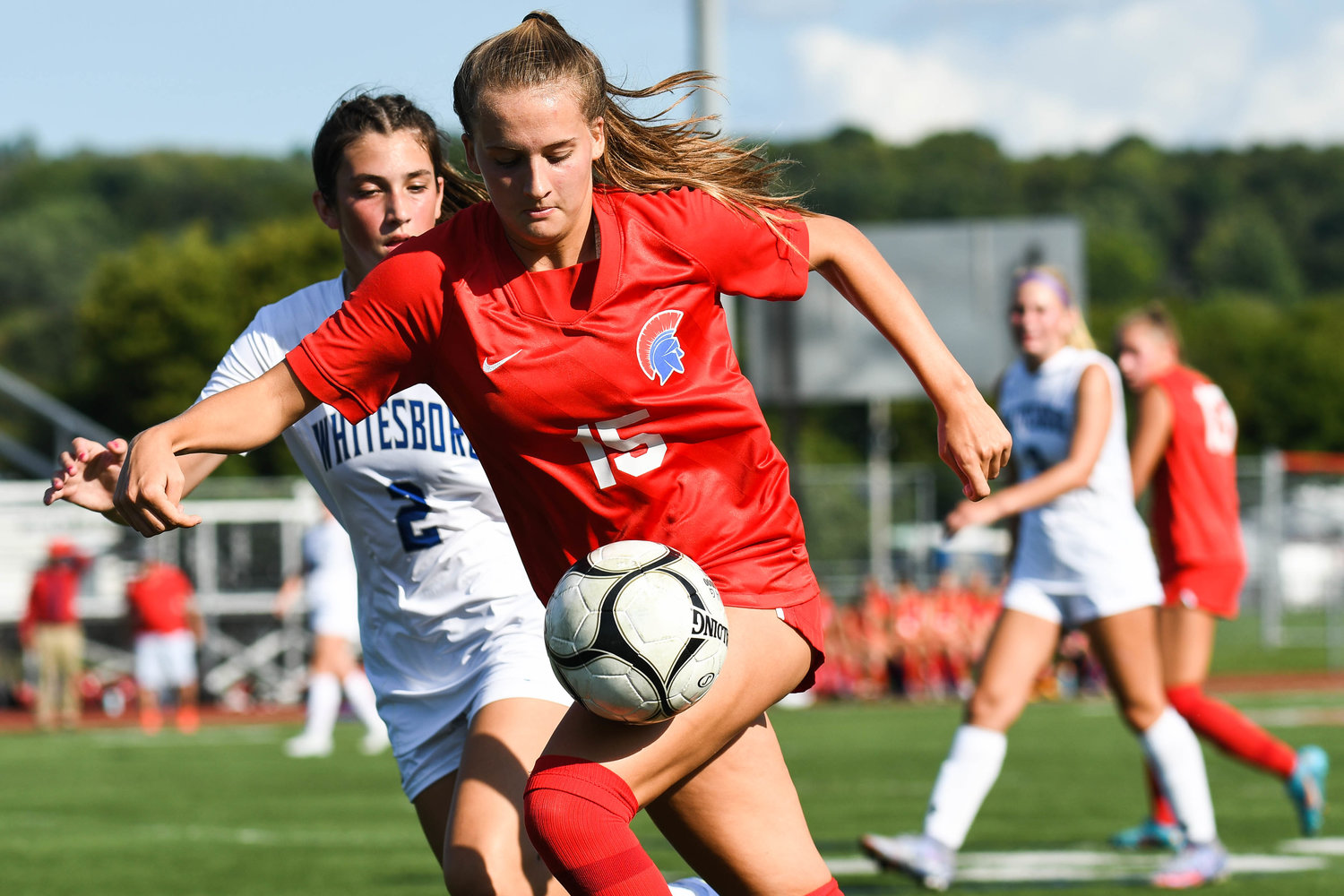 New Hartford’s Anna Rayhill moves the ball as Whitesboro’s Olivia Davis defends during the game on Thursday. Rayhill scored twice in the Spartans’ 5-0 win.