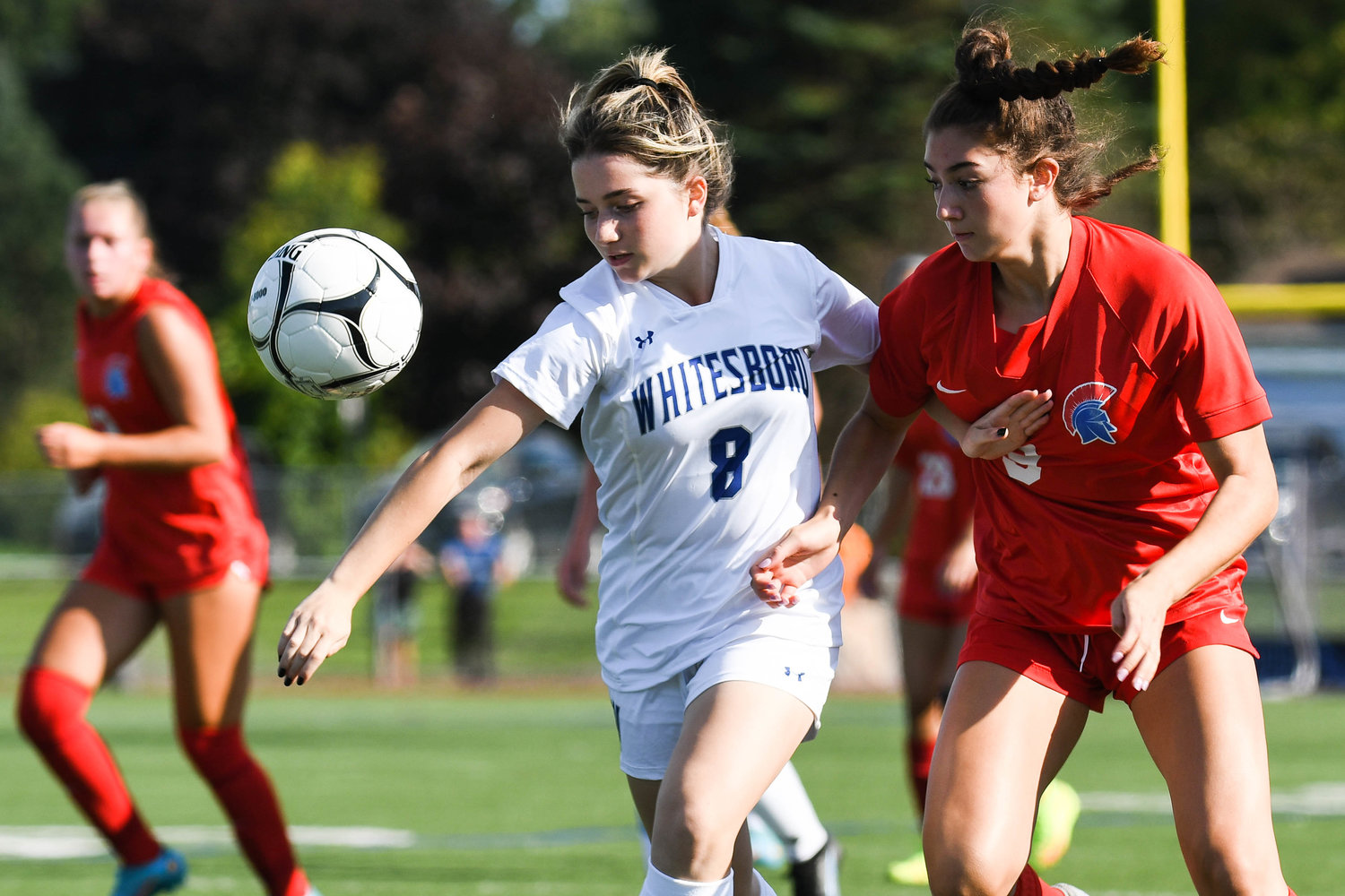 Whitesboro player Ellana Stucchi, left, fights for control of the ball with New Hartford’s Amanda Graziano during the game on Thursday. Graziano scored in the Spartans’ 5-0 win.