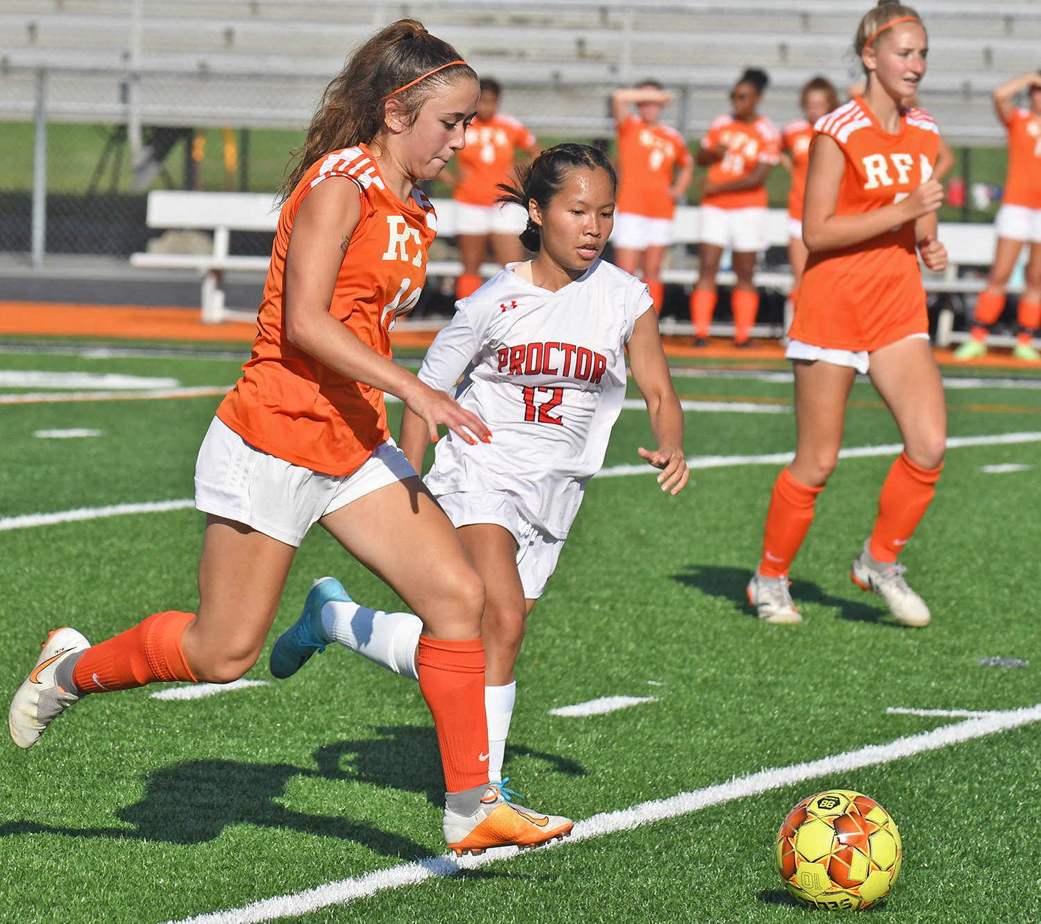 Rome Free Academy's Antonia Schillaci, left, sprints upfield to control the ball while challenged by Proctor's Nancy Shine during the first half of Thursday night's game at RFA Stadium. The Black Knights won 10-0 and Schillaci had two assists.