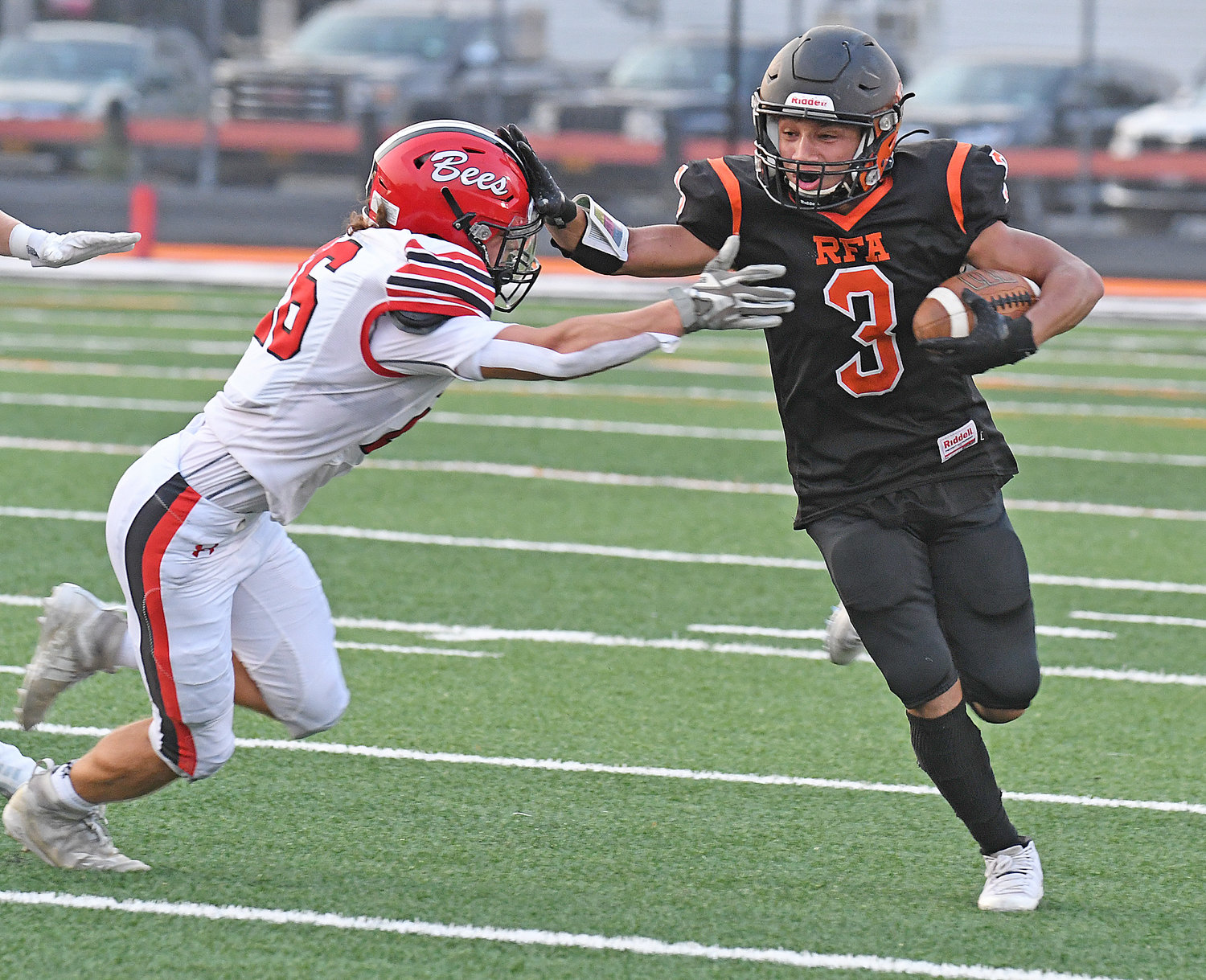 Lebron Bowman stiff arms Baldwinsville's Kaleb Paul in the first quarter of Friday night's game at RFA Stadium. Bowman scored on a 66-yard throw-and-catch in the second half but RFA lost 55-13.
