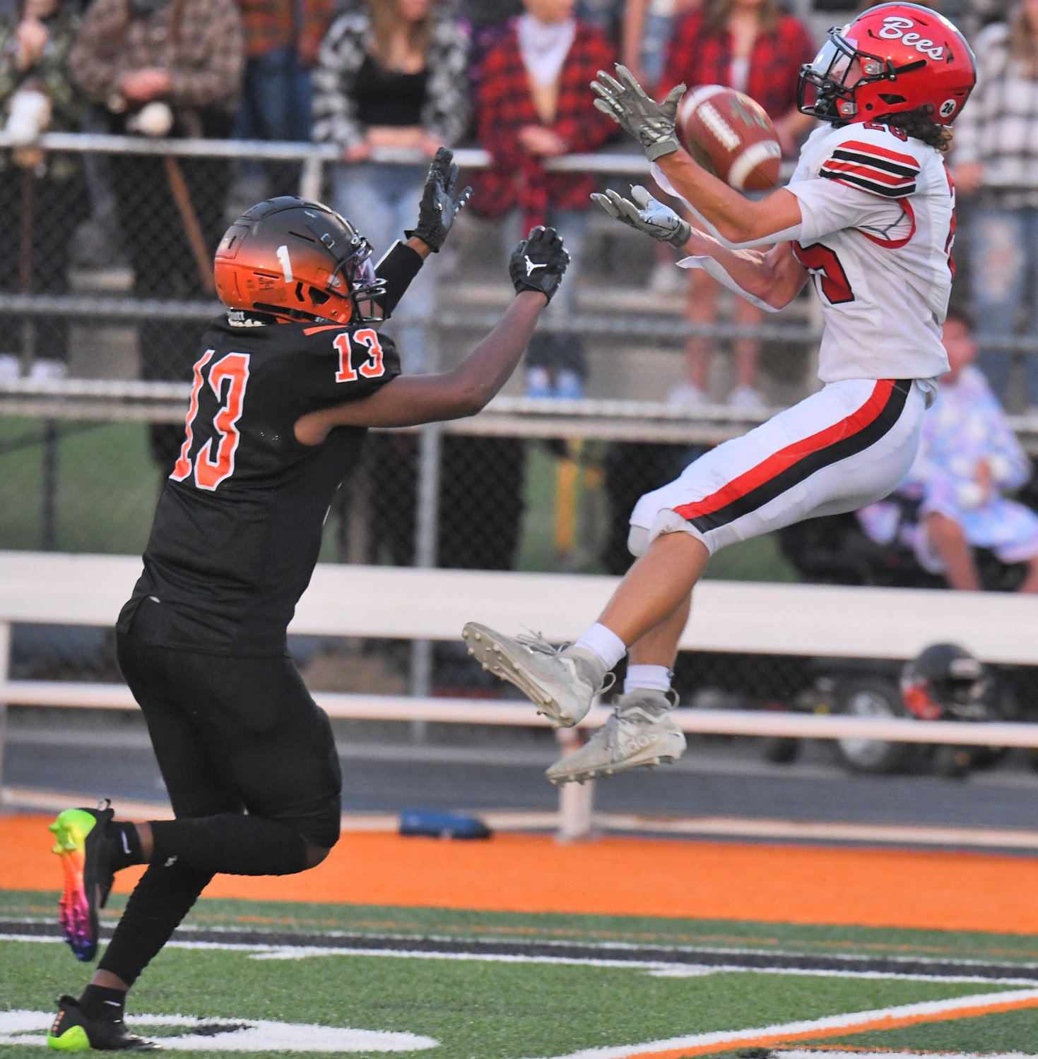 Kaleb Paul of Baldwinsville makes a catch over Rome Free Academy defender Austin DeJean in the second quarter Friday night at RFA Stadium. The Bees rarely passed, running almost every play in their 55-13 win.