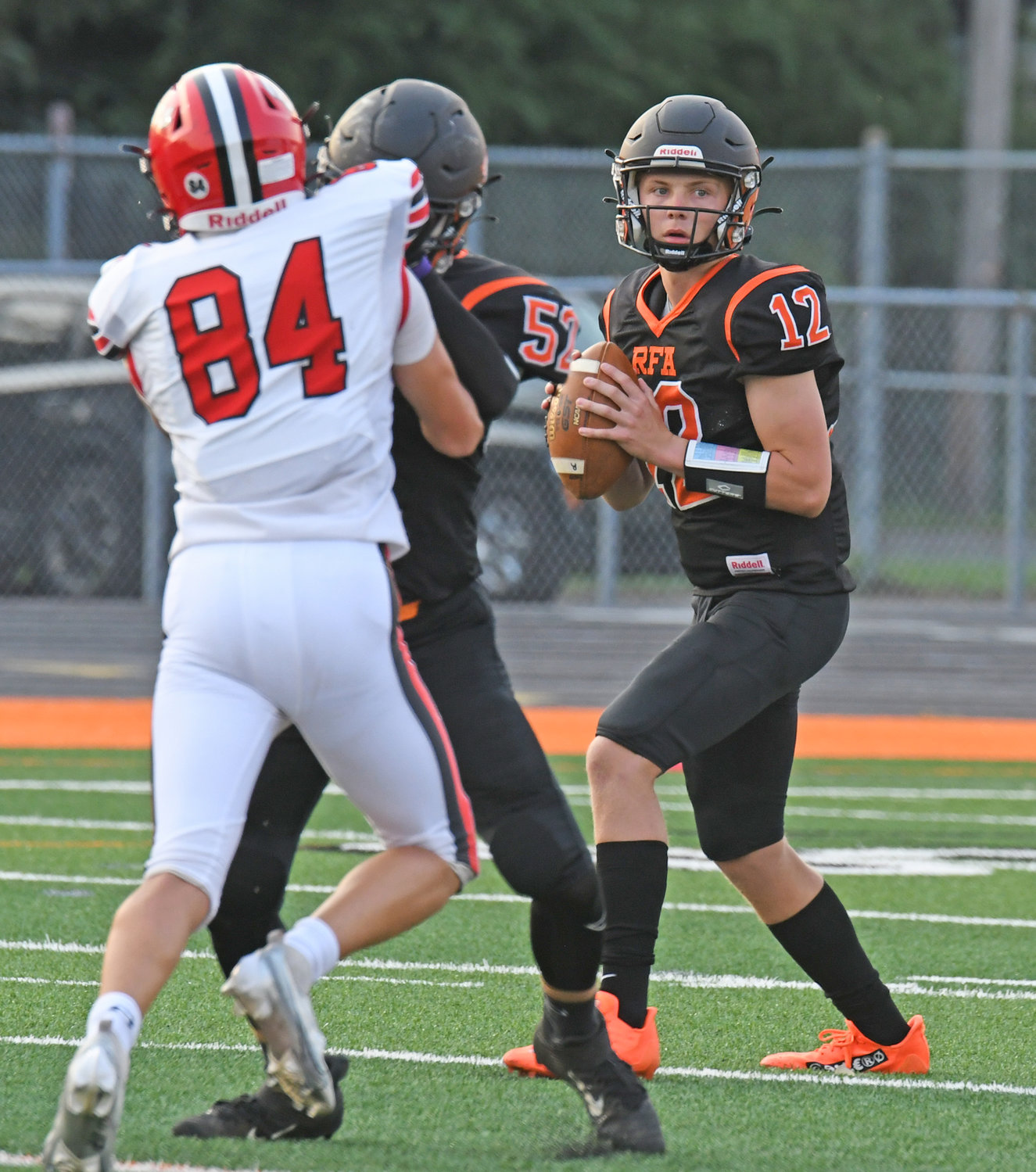 Rome Free Academy quarterback Evan Carlson-Stephenson looks for an open receiver with Josiah Holmes blocking Baldwinsville's Lucas Fawcett on the play in the first quarter at RFA Stadium Friday night. Carlson-Stephenson threw for 192 yards and two scores but the Black Knights lost 55-13.