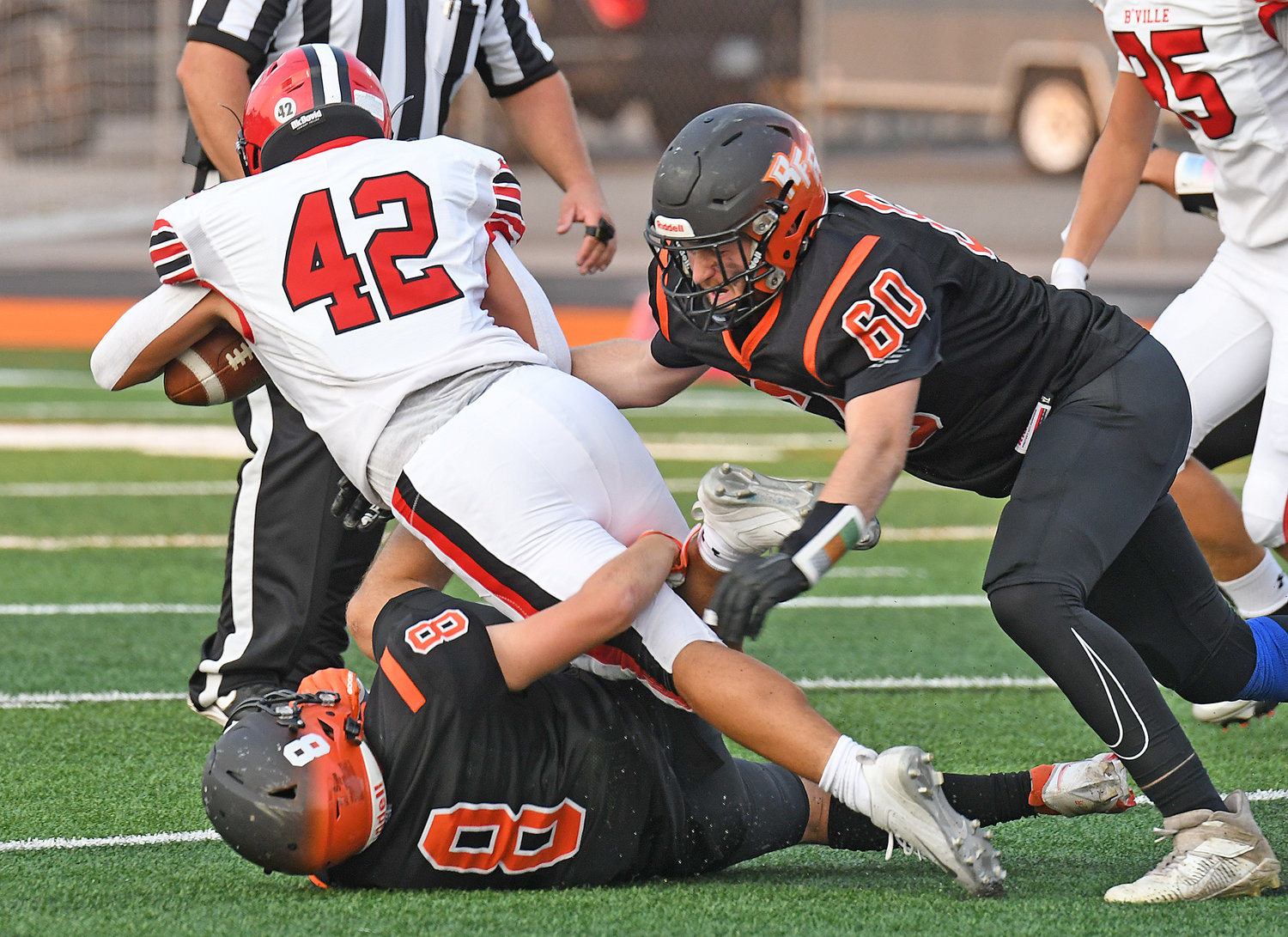 Rinaldo DiCastro (8) and Brian East tackle Baldwinsville's Nicholas Foster in the first quarter Friday night at RFA Stadium. The Bees won 55-13.