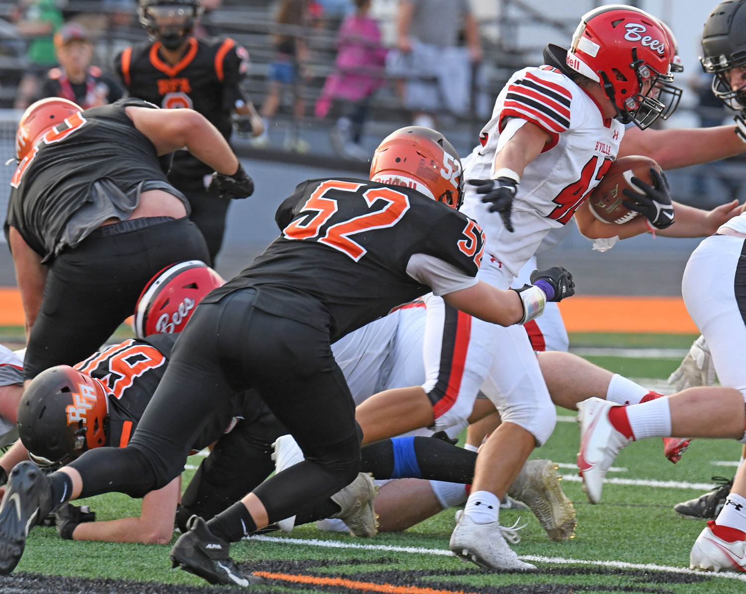 Josiah Holmes of Rome Free Academy tries to wrap up Baldwinsville fullback Nicholas Foster in the first quarter Friday night at RFA Stadium. The Bees won 55-13.