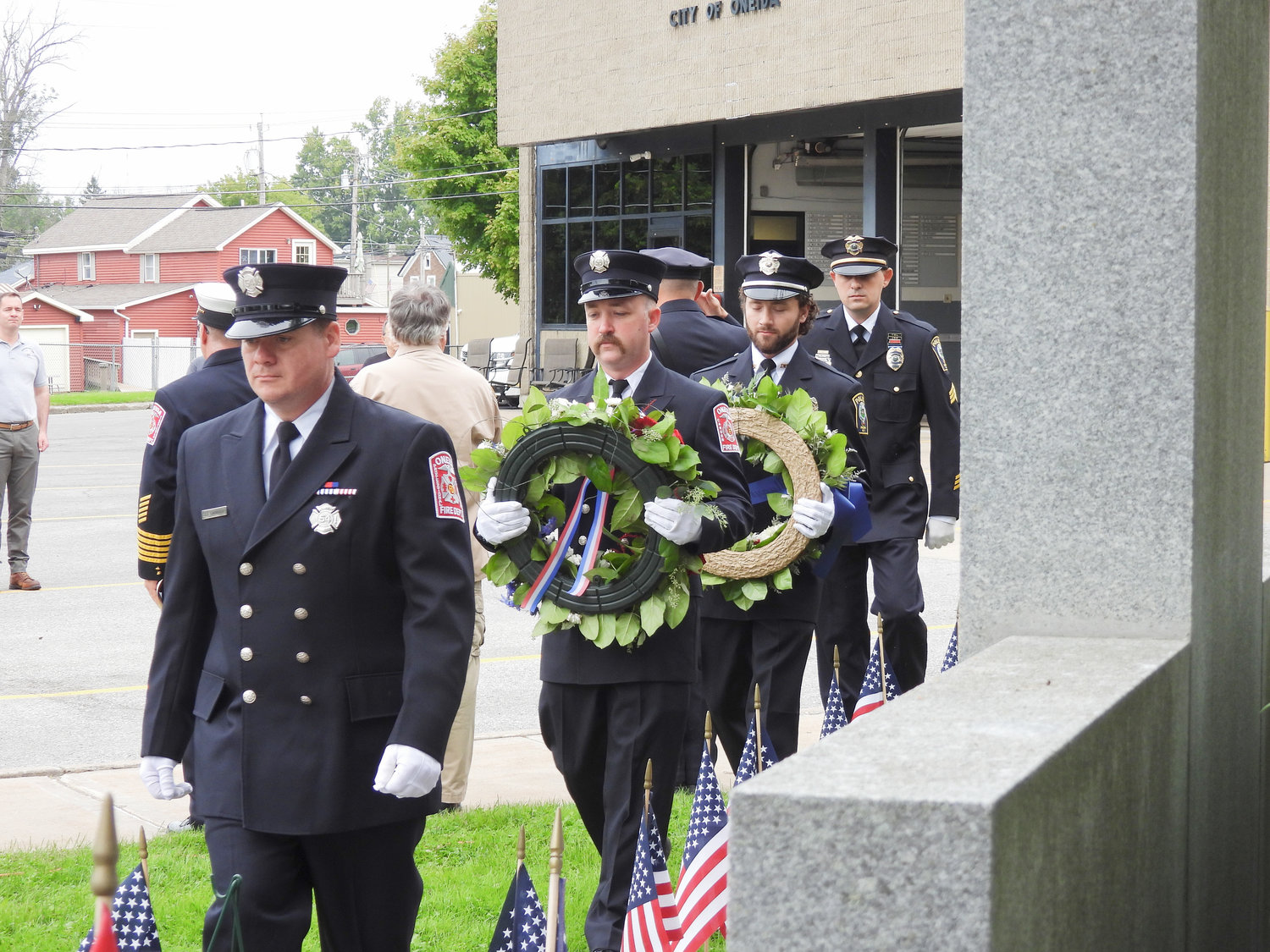The Oneida Fire Department and Oneida Police Department carry the wreaths for the city's 9/11 Remembrance Ceremony on Sunday.