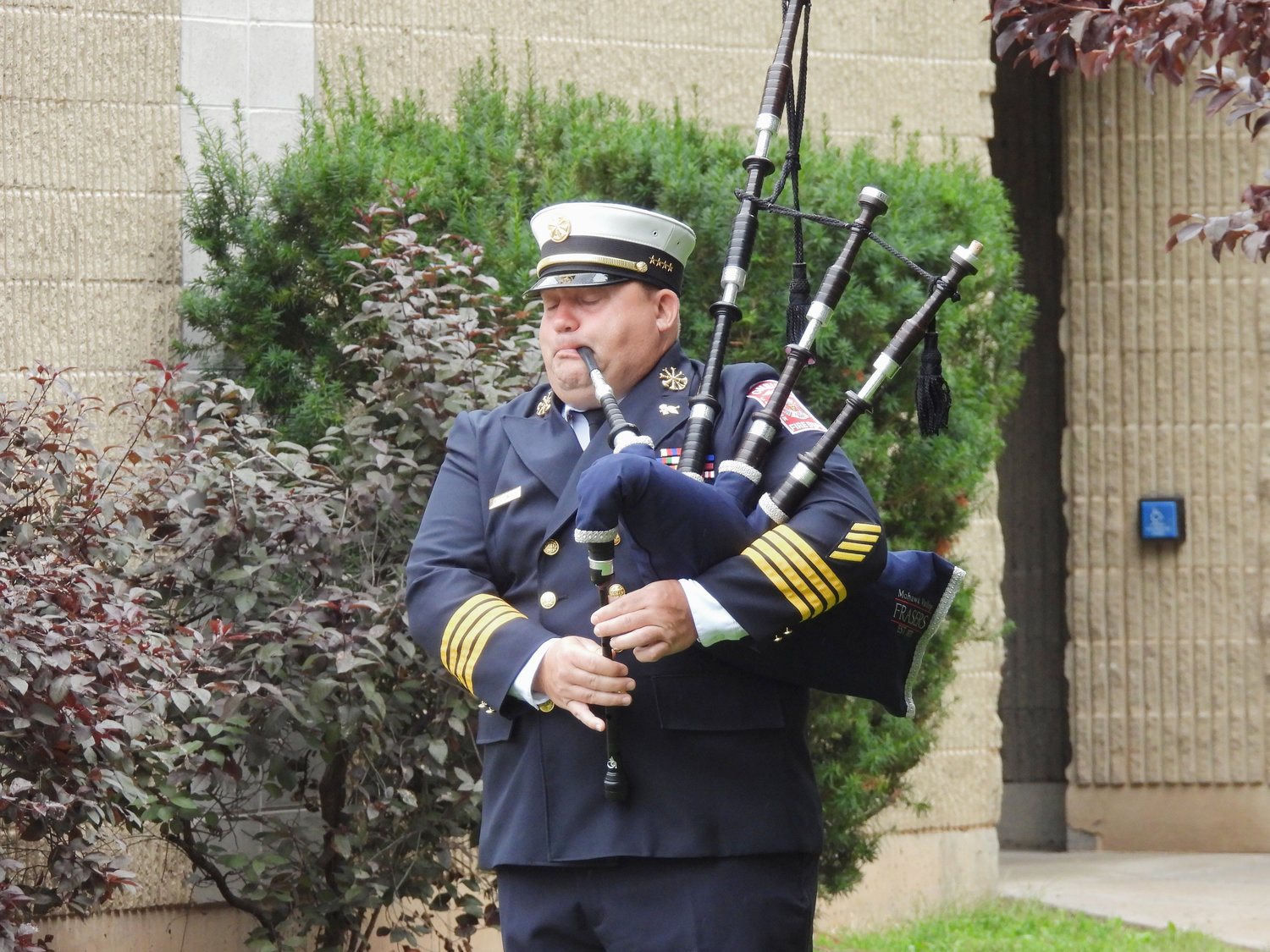Oneida Fire Department Assistant Chief Rob Cowles plays "Amazing Grace" at the city of Oneida's 9/11 Remembrance Ceremony on Sunday.