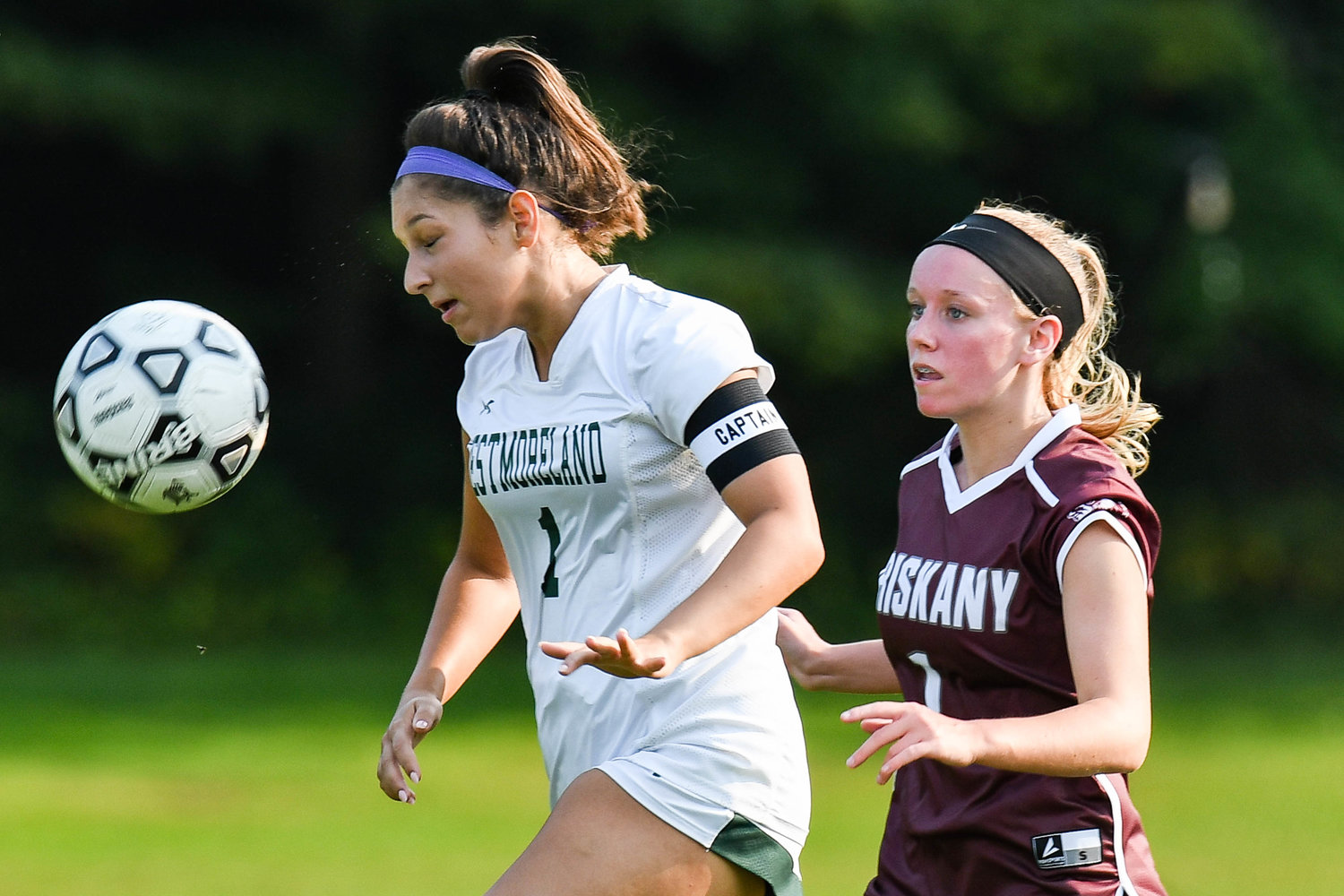 Westmoreland's Bailee Serianni heads the ball as Oriskany's Addison Fabio players her close during the game on Friday at Bernie Block Field in Oriskany. Westmoreland won 3-0.
