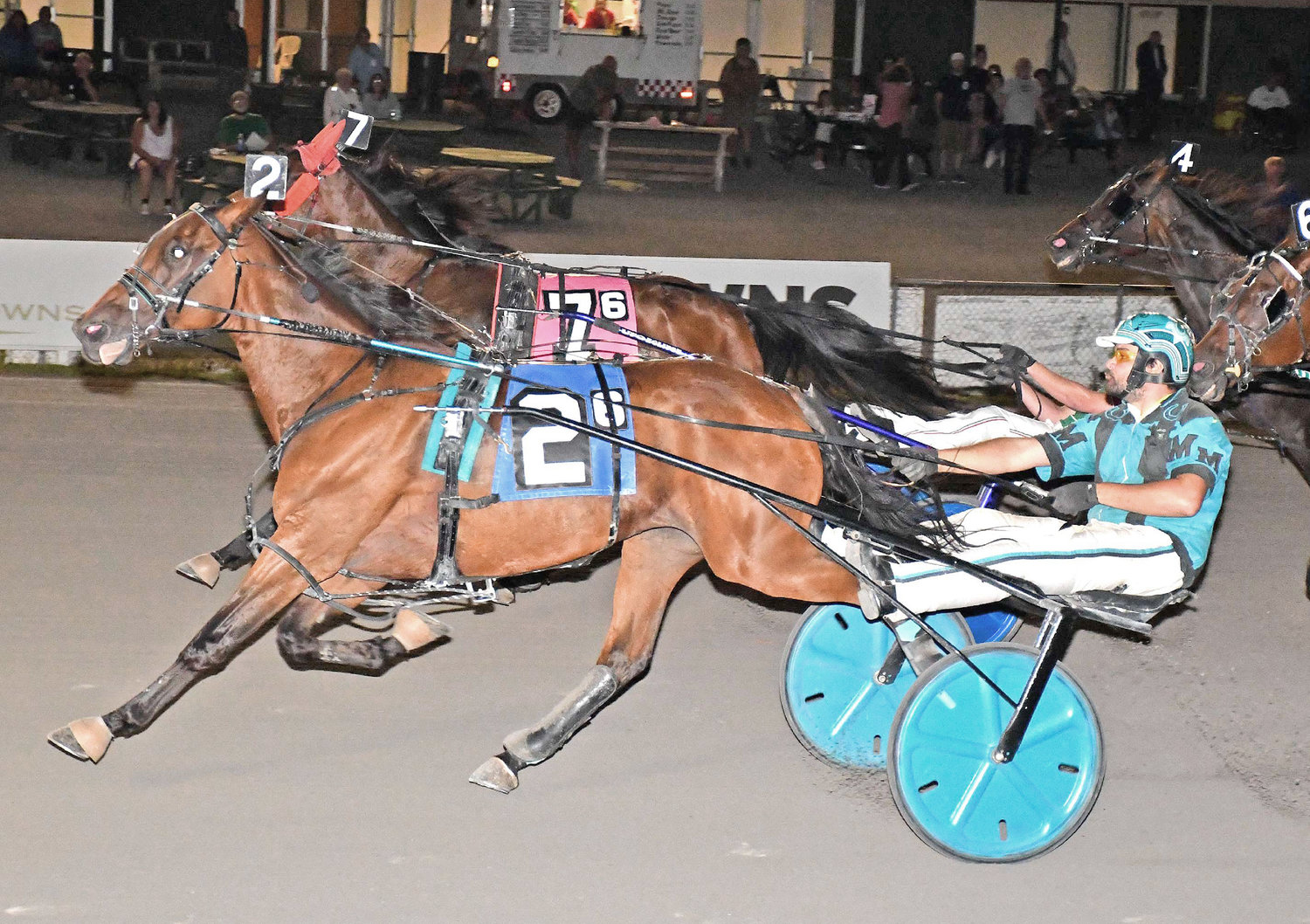 Michael Miller drives American JJ to victory on Saturday night in the featured $6,600 trot with wild finish at Vernon Downs.