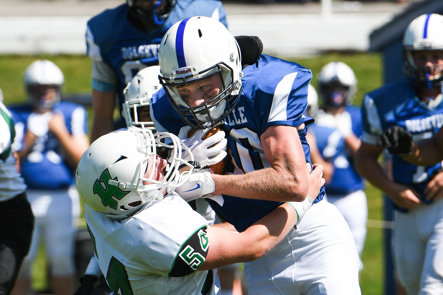 Dolgeville running back Cameron Dager rushes through Herkimer defender Michael Goodson during the Class D game on Saturday. The Blue Devils won 68-20.