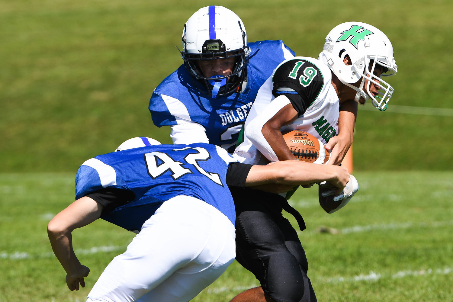 Herkimer returner Terrance Jones (19) is tackled by Dolgeville players Trever Borst and Grayson Eggleston (42) during the Class D game on Saturday. The Blue Devils won 68-20.