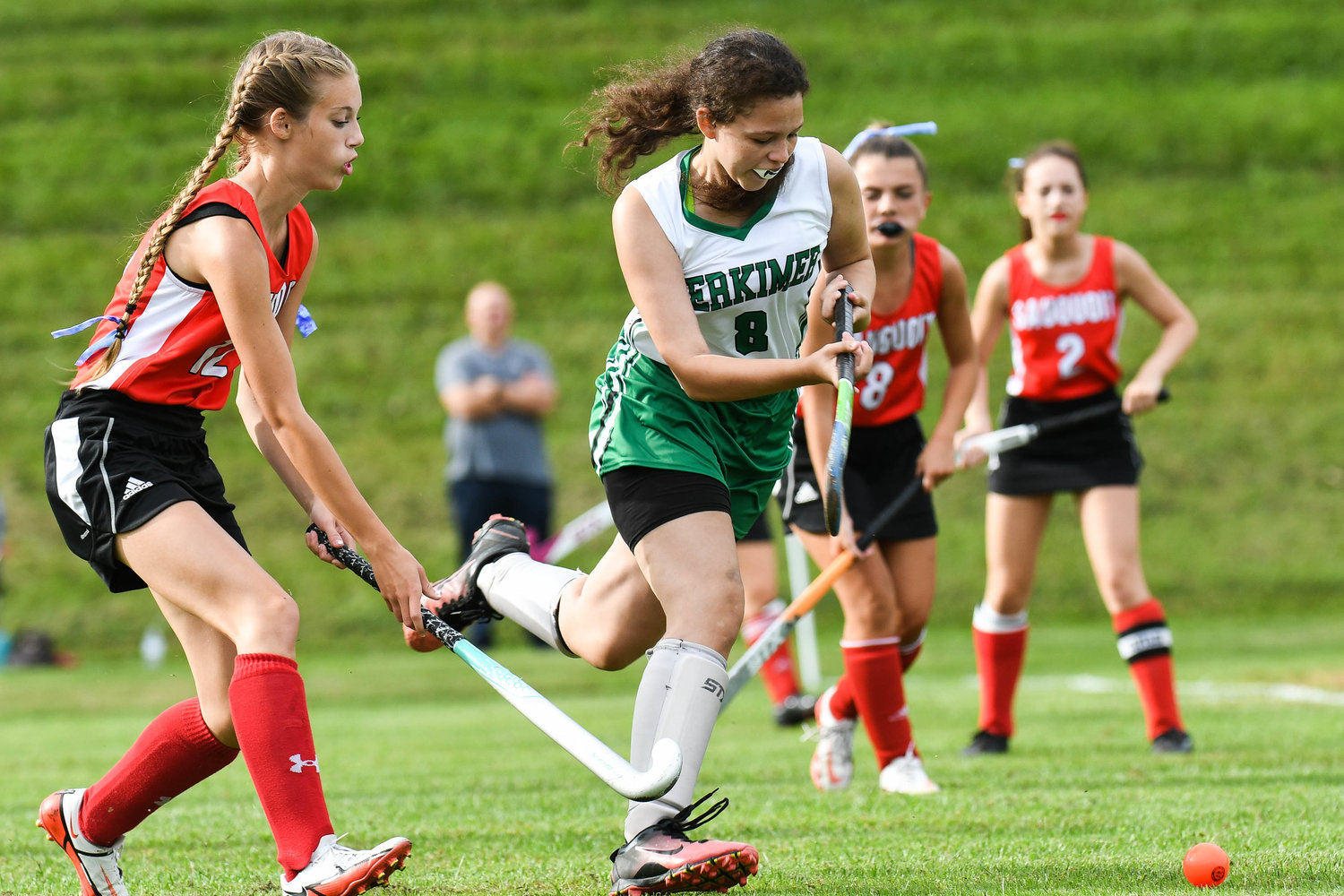 Herkimer player Iesha Deubel (8) moves the ball against Sauquoit Valley defender Emilie Fancett during the Center State Conference field hockey game on Monday in Herkimer. The two teams played to a scoreless tie.