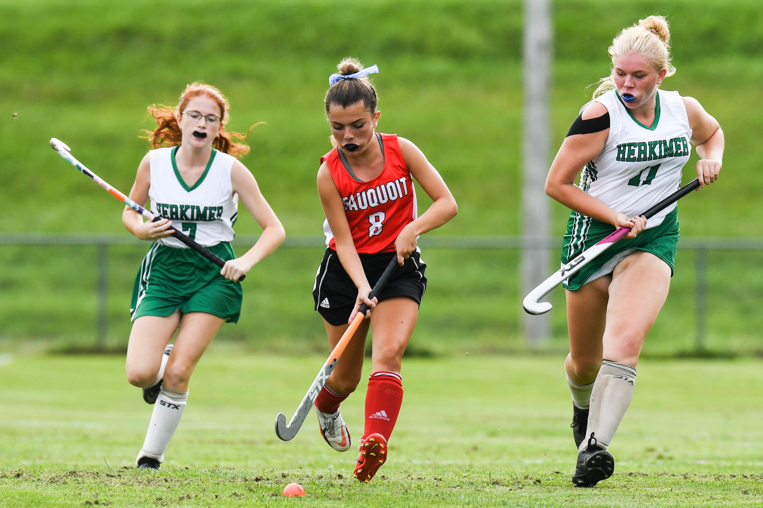 Sauquoit Valley player Isabella Canarelli (8) moves the ball between Herkimer defenders Hanna Uebele (7) and Emily Marquissee (11) during the Center State Conference field hockey game on Monday in Herkimer. The two teams played to a scoreless tie.