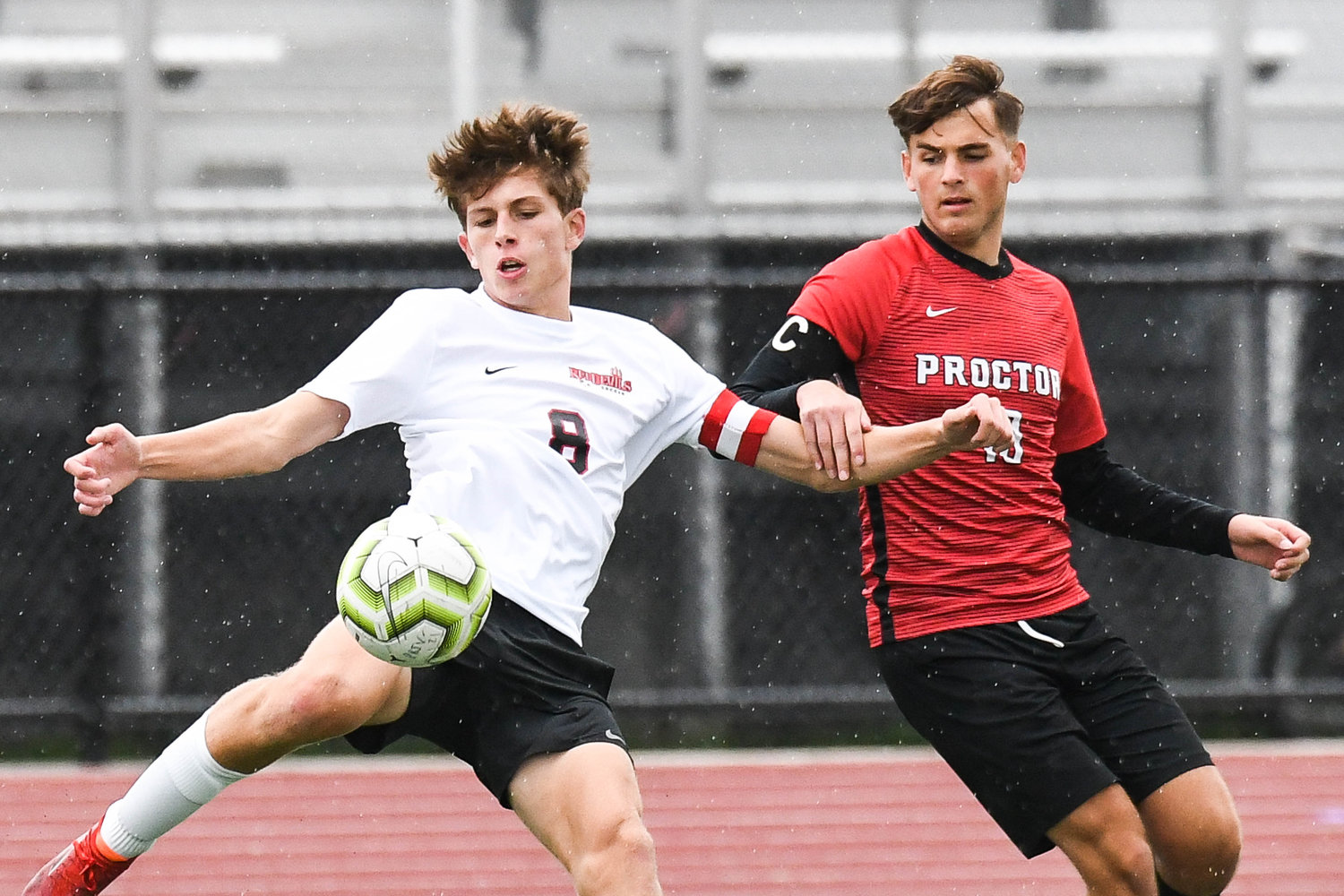 Vernon-Verona-Sherrill’s Ryan Mumford, left, attempts to clear the ball as Proctor player Ervin Ruznic defends Tuesday. Ruznic scored a goal in the Raiders’ 4-0 Tri-Valley League win.