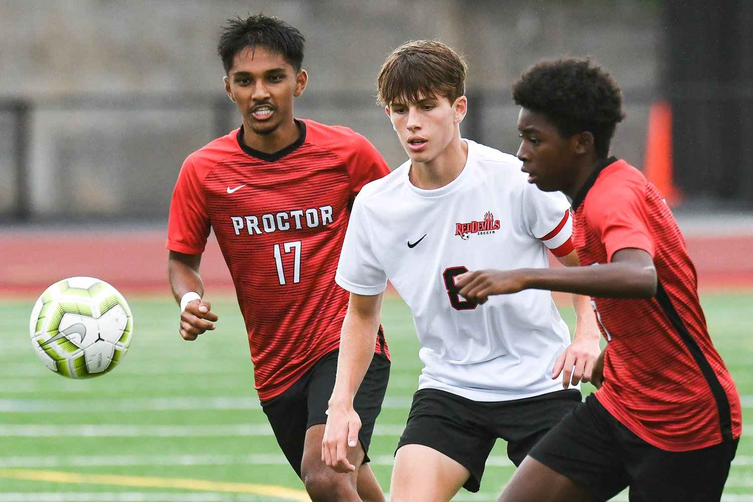 VVS player Ryan Mumford, center, attempts to settle the ball as Proctor players Siidahmed Somow, right, and Weya Myint (17) defend during the soccer game on Tuesday.