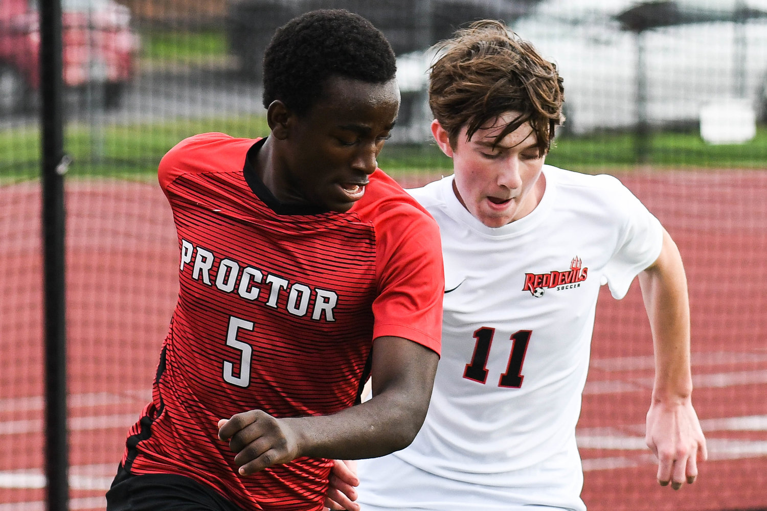 VVS player Nolan Miller (11) defends Proctor player Hussein Abukar (5) during the soccer game on Tuesday.