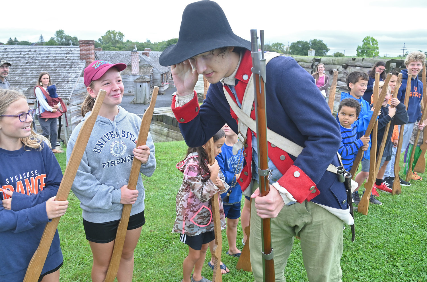 Elijah Braun listens for Liesl Saufley, 11, to say 'ting' during a musket drill Wednesday at Fort Stanwix in Rome. The 'ting' is the sound of the gun's ram rod hitting the bottom of the gun barrel.