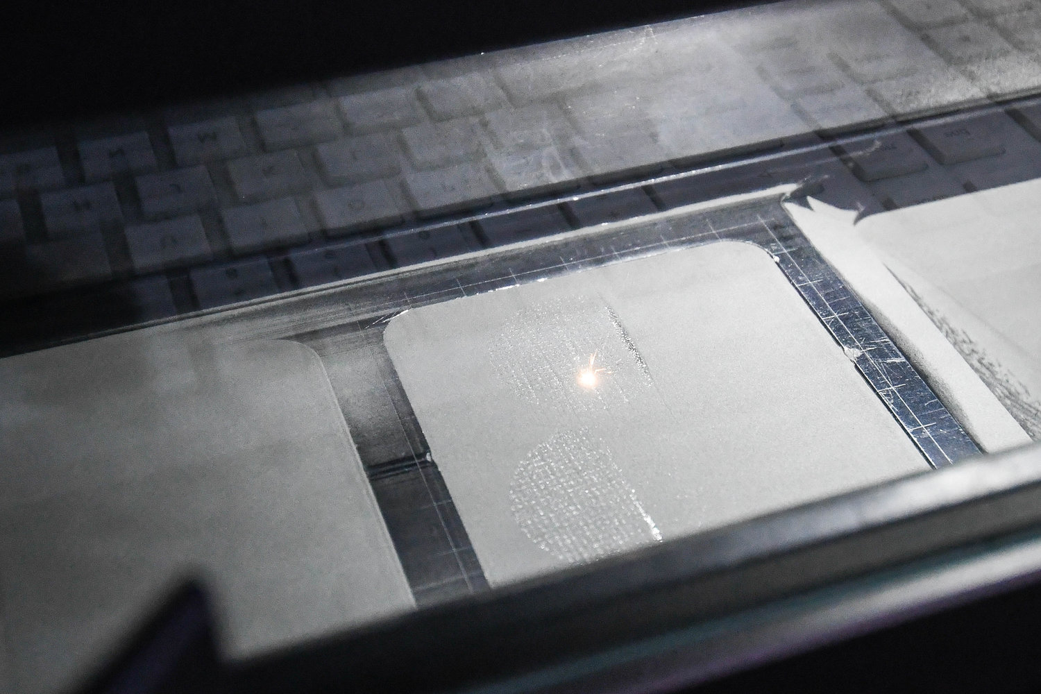 A laser printing machine etches into material at Mohawk Valley Community College.