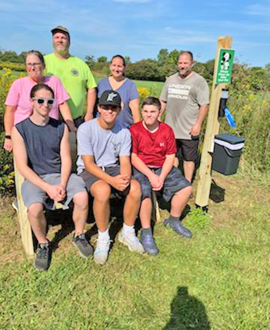 Volunteers take a quick break from installing a bench and waste receptacle along a walking trail at the Humane Society of Rome animal shelter at 6247 Lamphear Road in Rome. From left, front row: Russell Sortino, Gaetano Nasci, and Henry Inserra; back row: Susan Nasci, Scout Master Mike Dodson, Sarah Inserra, and Steve Copperwheat. Not pictured is James Steates.