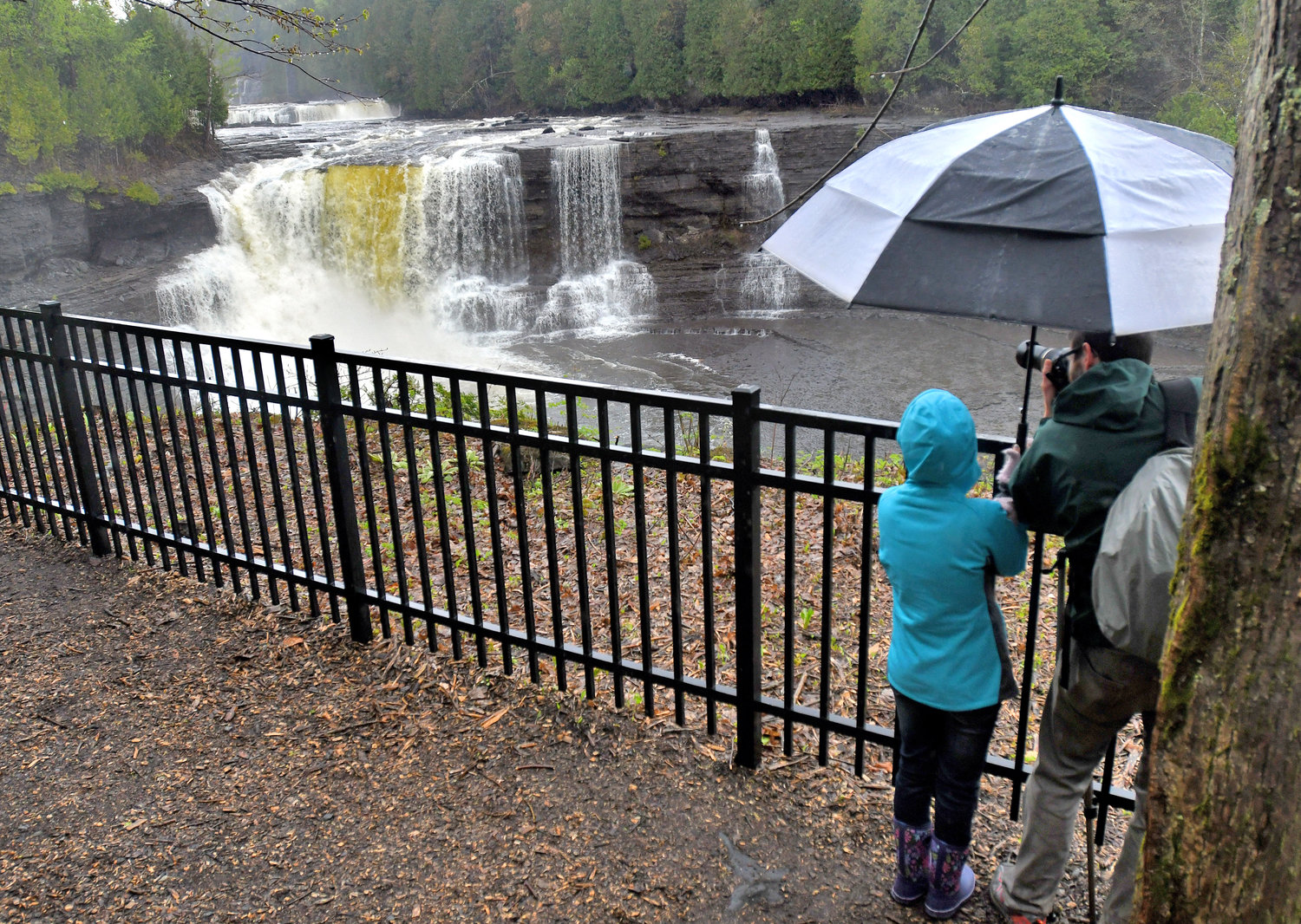 Josh Ostrouch and his wife Melinda Ostrouch from Syracuse take advantage of the Trenton Falls Scenic Trail for a good photo op of the Upper Falls.