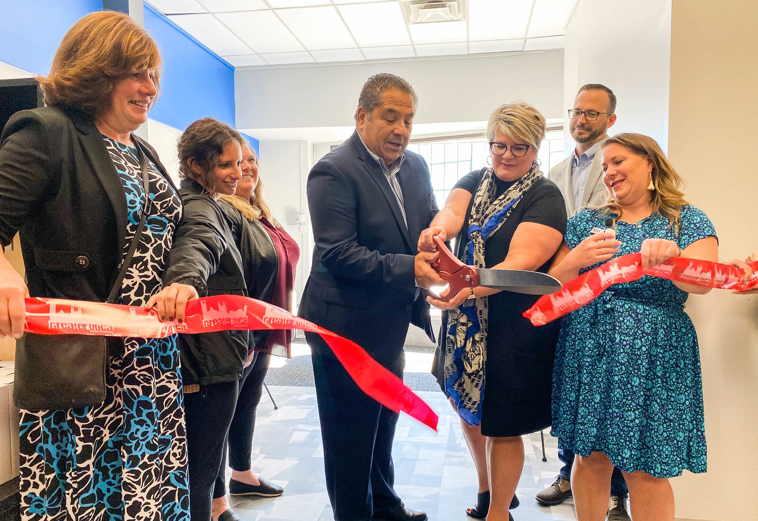 Officials gather to cut the ribbon at the grand opening of Carmina Wood Design, an architecture, engineering and interior firm, which has opened an office in downtown Utica at 54 Franklin Square.