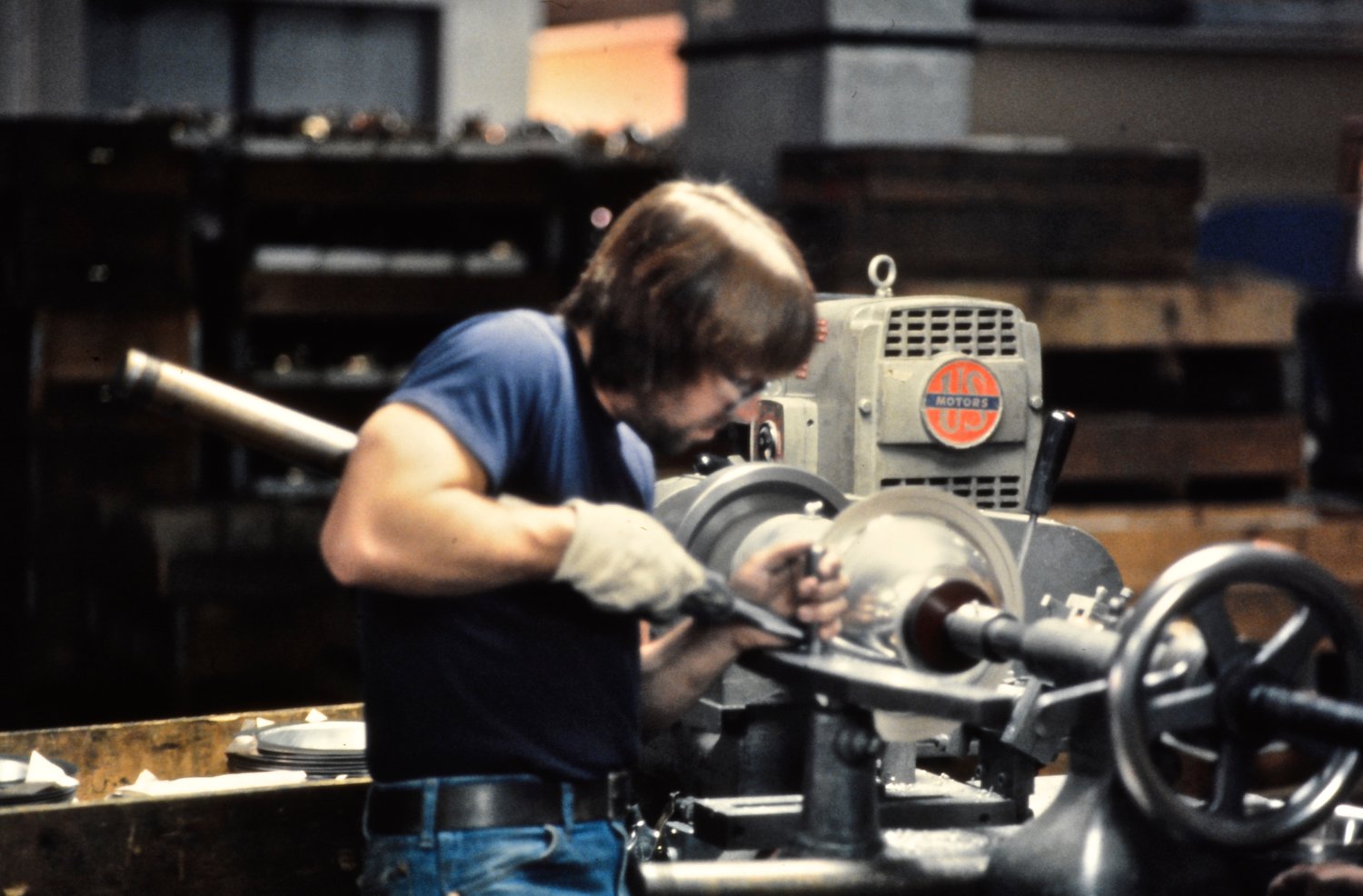 An Oneida Limited employee trims and polishes a hollowware bowl.