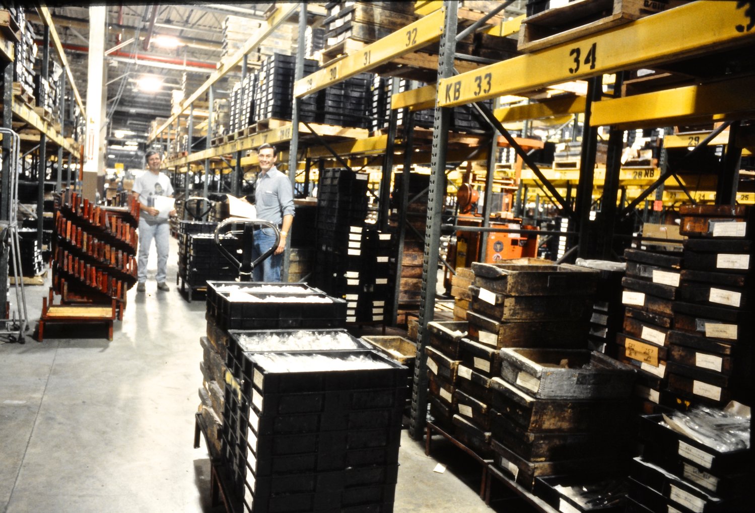 Two men restock inventory in the Oneida Limited warehouse.