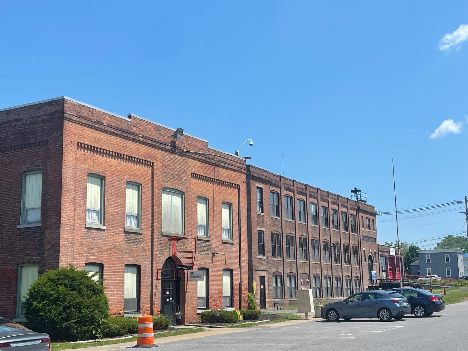 The Oneida Limited factory as it sits today. These buildings housed manufacturing offices and labs. The near building is presently leased on the first floor to a financial planner and a photographer.