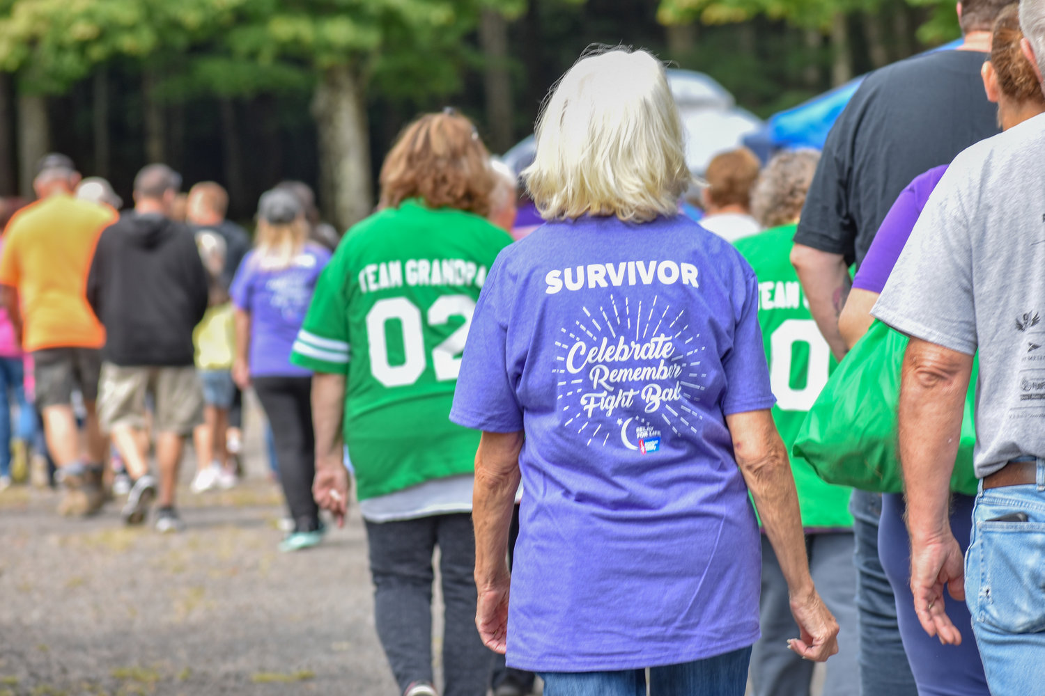 A cancer survivor walks proudly to kick off Relay for Life CNY on Saturday, Sept. 17, 2022.
