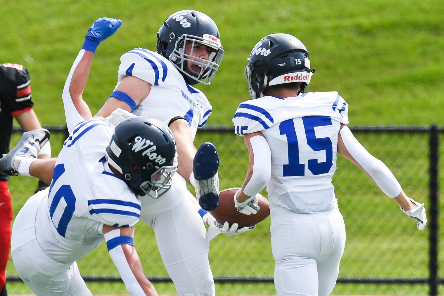 Whitesboro player Anthony Dorozynski, center, celebrates with teammates Joshua Bono (10) and Spencer Cater (15) after scoring a touchdown. Dorozynski finished with 138 yards receiving and touchdown on five catches.