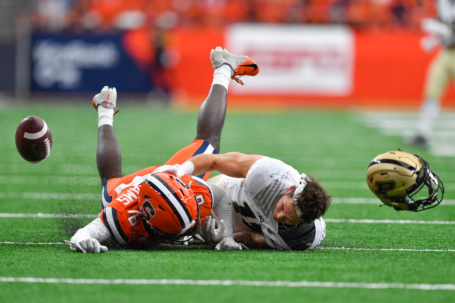 Purdue wide receiver Charlie Jones, right, loses his helmet and the ball while diving for a pass defended by Syracuse defensive back Garrett Williams during the first half of an NCAA college football game in Syracuse, N.Y., Saturday, Sept. 17, 2022.