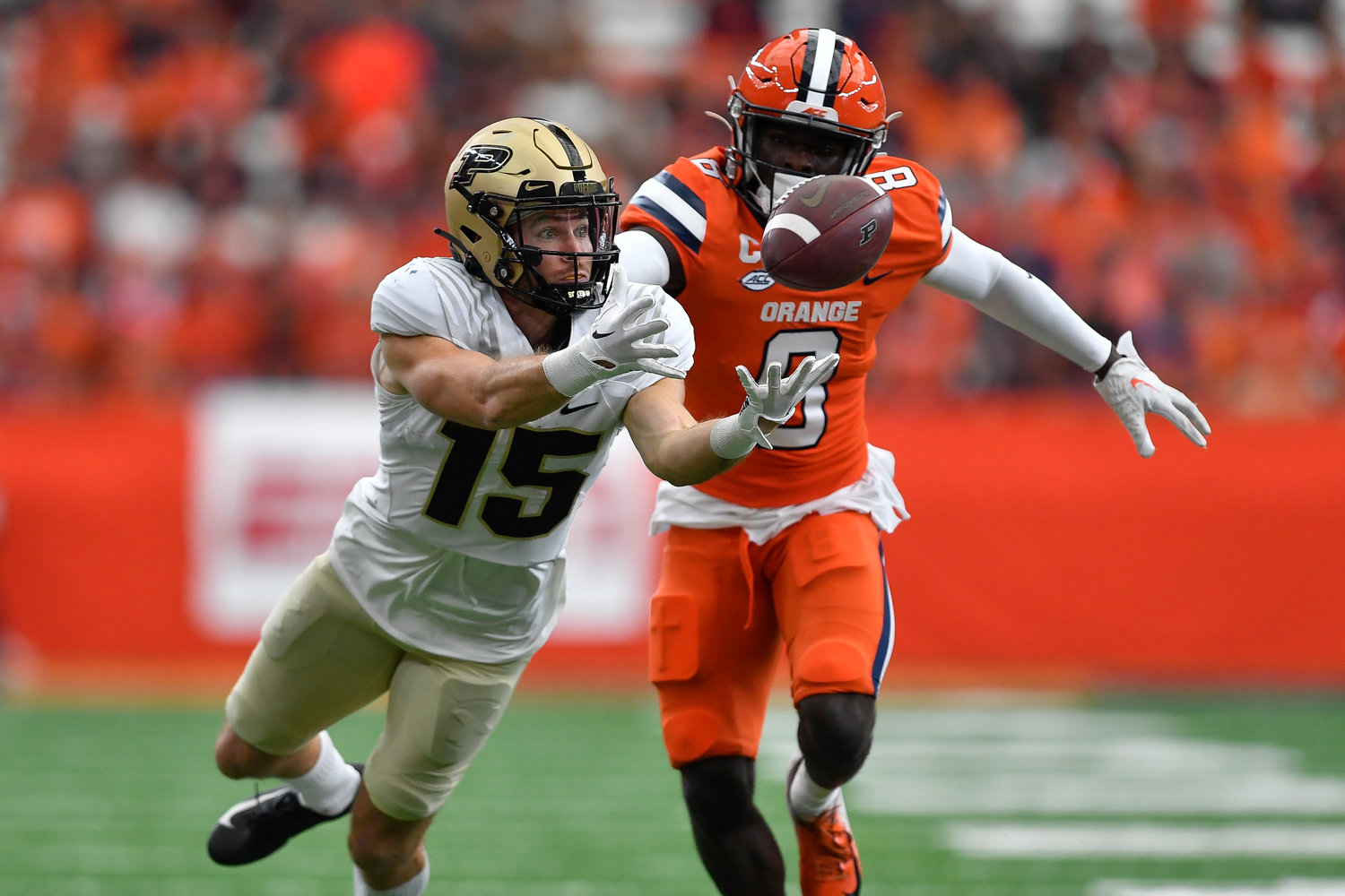 Purdue wide receiver Charlie Jones, left, reaches for a pass as Syracuse defensive back Garrett Williams defends during the first half of an NCAA college football game in Syracuse, N.Y., Saturday, Sept. 17, 2022.