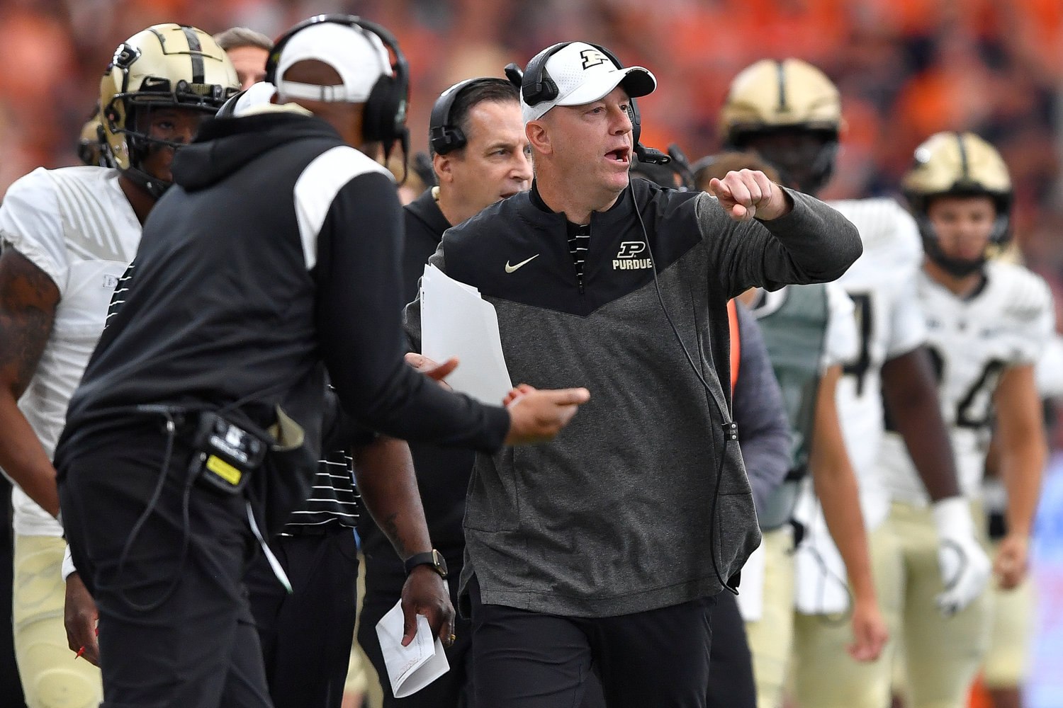 Purdue head coach Jeff Brohm, center, calls a play during the first half of an NCAA college football game against Syracuse in Syracuse, N.Y., Saturday, Sept. 17, 2022.