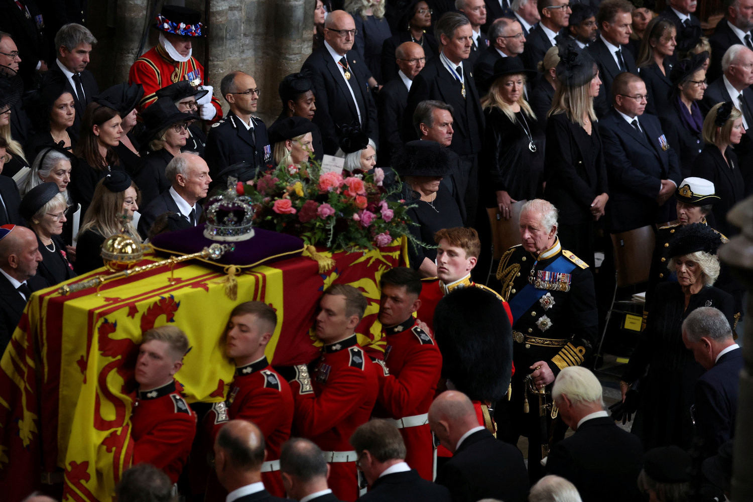 Britain's Queen Elizabeth's coffin is carried as King Charles III, Camilla, the Queen Consort and Princess Anne follow, during the funeral in London, Monday Sept. 19, 2022.