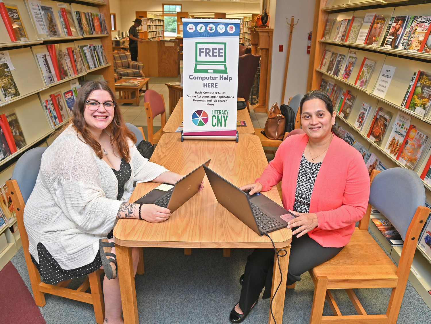 Lydia Torres, a digital literacy program coordinator with Literacy CNY, left, and Farhat Rahim, a Literacy CNY volunteer, pose Monday at the New Hartford Public Library. The library offers computer help from 11 a.m. to 2 p.m. and 5-8 p.m. Mondays thanks to Literacy CNY.