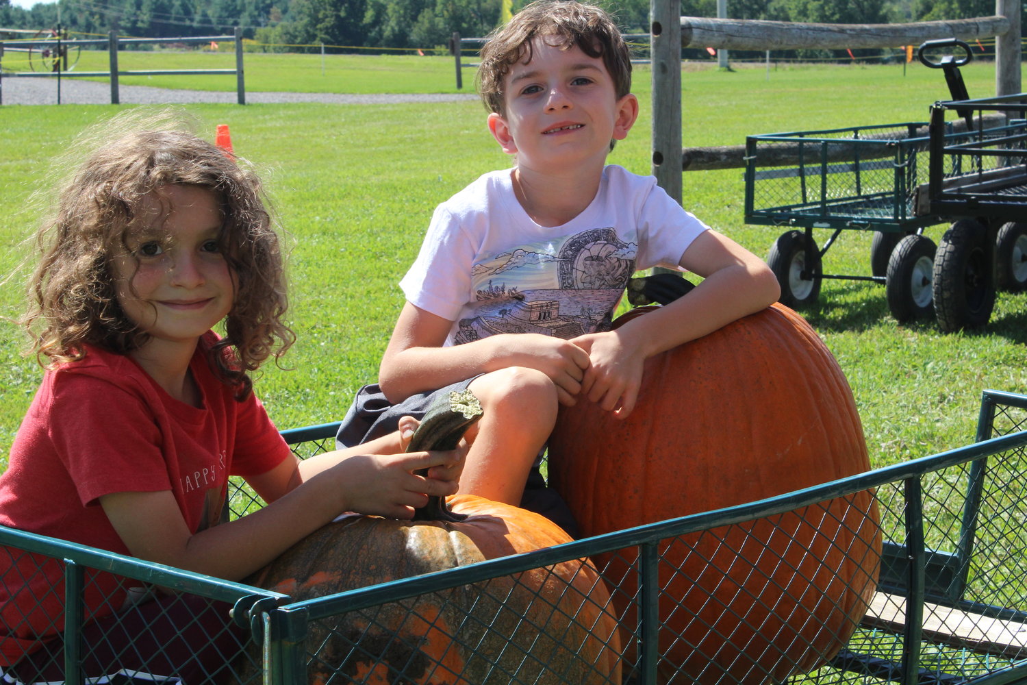 Lincoln, at left, and Emerson Price display the fruits of their labor from the u-pick pumpkin patch.