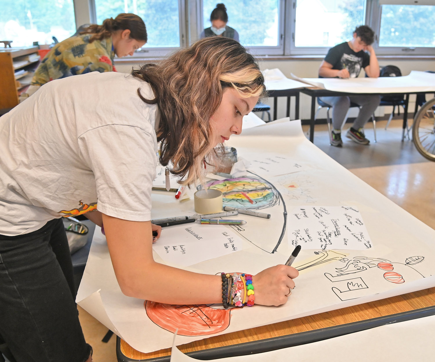 New Hartford senior Sophie Mandia works on her drawing Monday in art class.