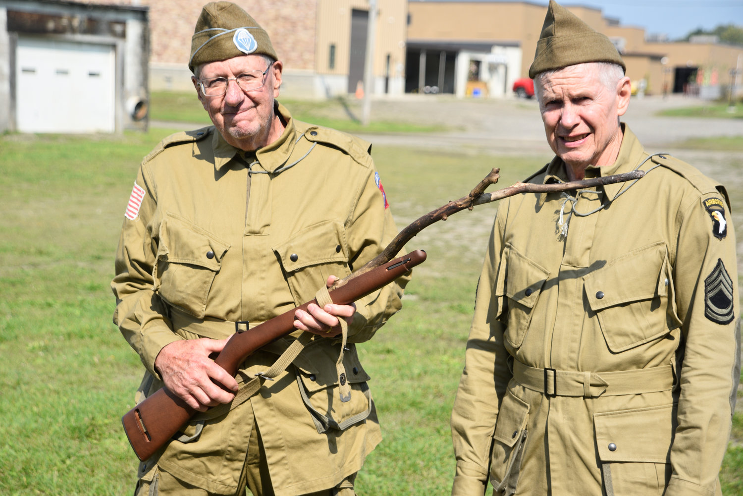 World War II reenactors Dan O’Brien of Chenango Bridge, left, and Kenny Gow of Binghamton placed a stick in a rifle stock to mock the state’s recently amended concealed carry law, which they say bans them from using inoperable weapons during encampments.