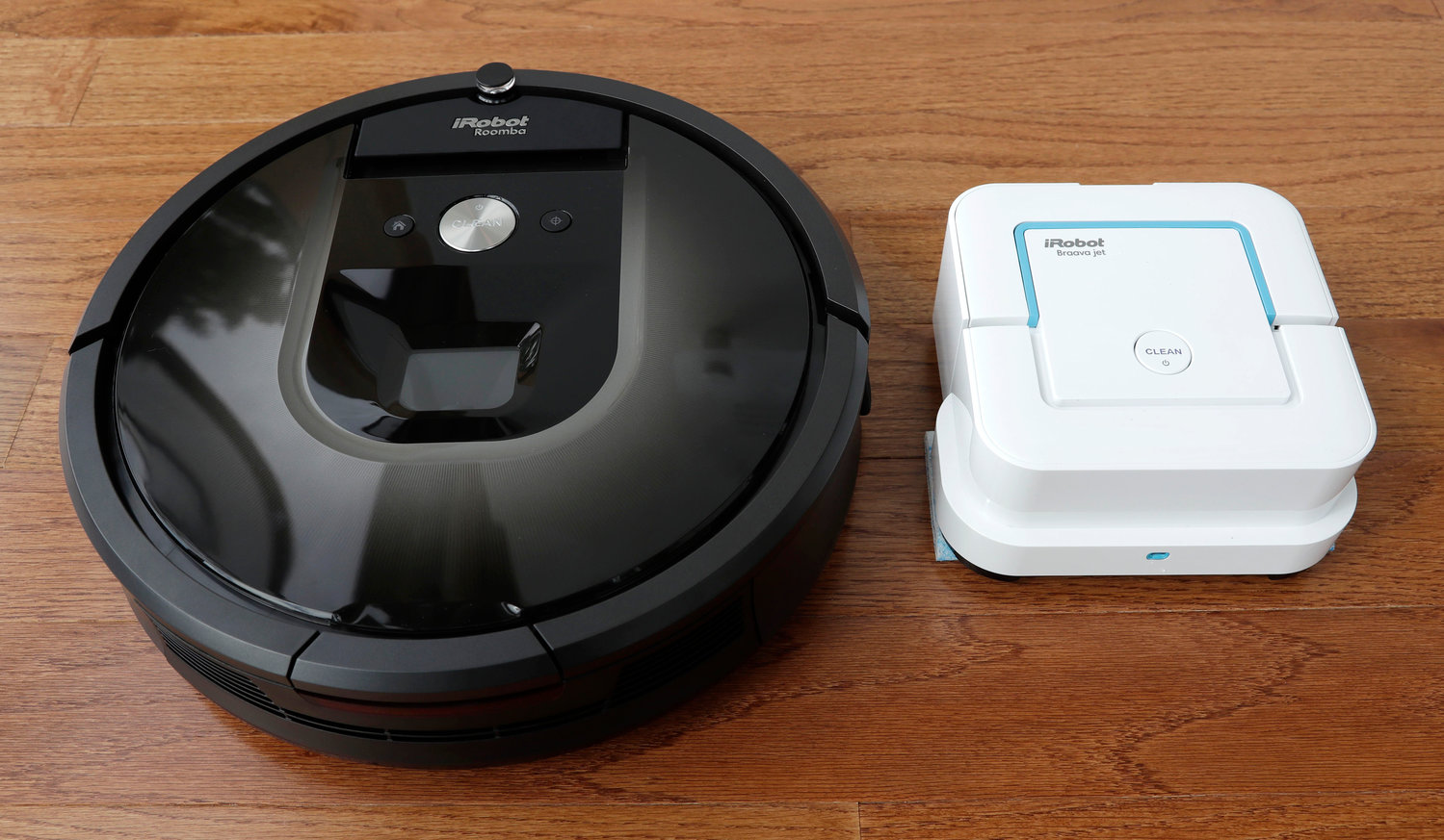 An iRobot Roomba vacuum, left, and Braava Jet floor cleaner are displayed at the company’s headquarters in Bedford, Mass.