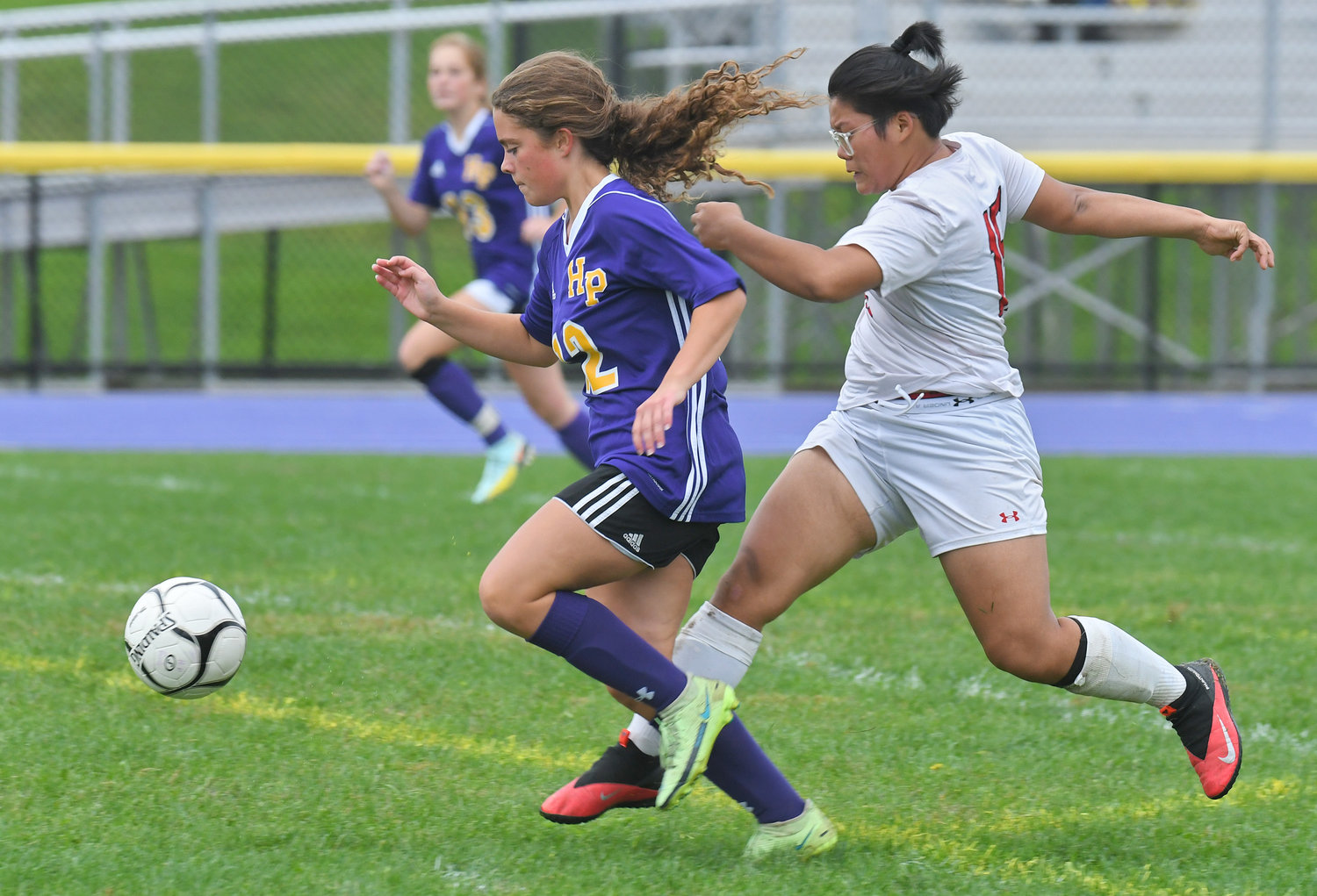 Holland Patent’s Brianna Mullins out runs Proctor’s Hser Eh Ler Paw to the goal and scored the first goal of the game and the only goal in the first half Tuesday at Holland Patent. The hosts won 2-0.