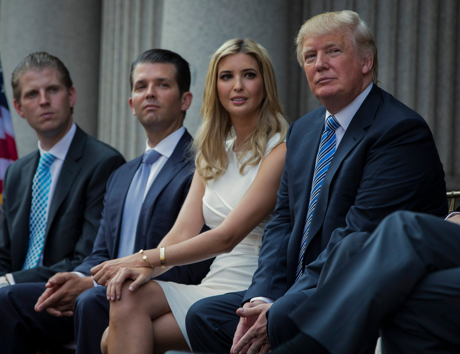 FILE - Donald Trump, right, sits with his children, from left, Eric Trump, Donald Trump Jr., and Ivanka Trump during a groundbreaking ceremony for the Trump International Hotel on July 23, 2014, in Washington. New York‚Äôs attorney general sued former President Donald Trump and his company on Wednesday, Sept. 21, 2022, alleging business fraud involving some of their most prized assets, including properties in Manhattan, Chicago and Washington, D.C. (AP Photo/Evan Vucci, File)